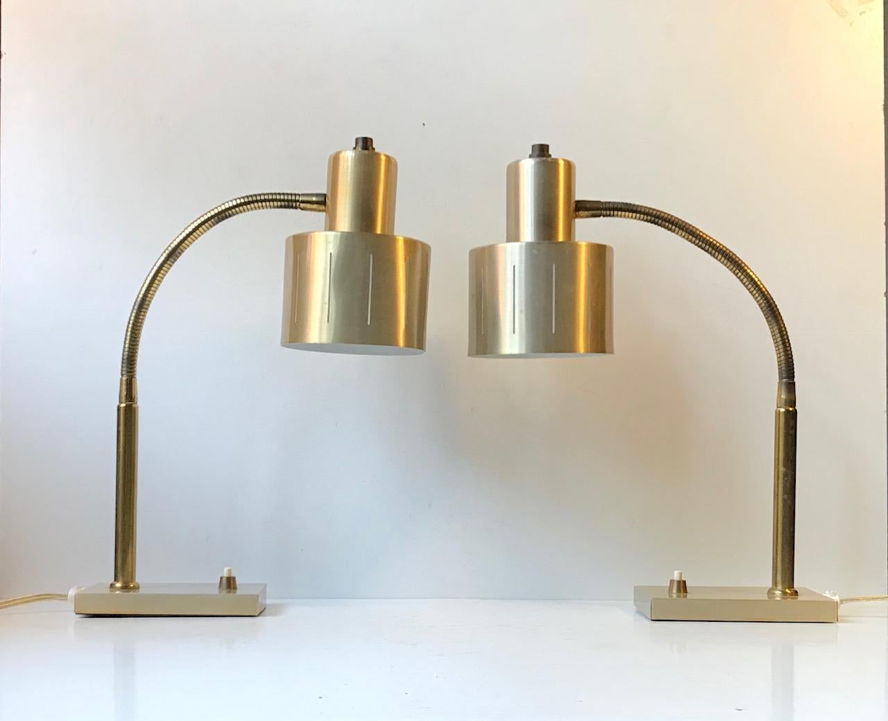 Matching pair of fully adjustable table light by Vitrika. The lights features flexible brass goose necks, perforated shades and small stylish on/of switches to the bases. These lights were manufactured and designed by Vitrika in Denmark during the