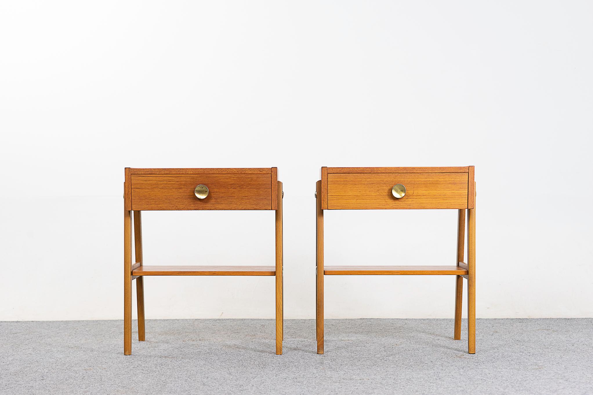 Teak midcentury bedside pair, circa 1960s. Slender splayed legs and hady shelf. Dovetailed drawer with metal pull offers storage for small items. 

Unrestored item, some very minor marks consistent with age.

Please inquire for international