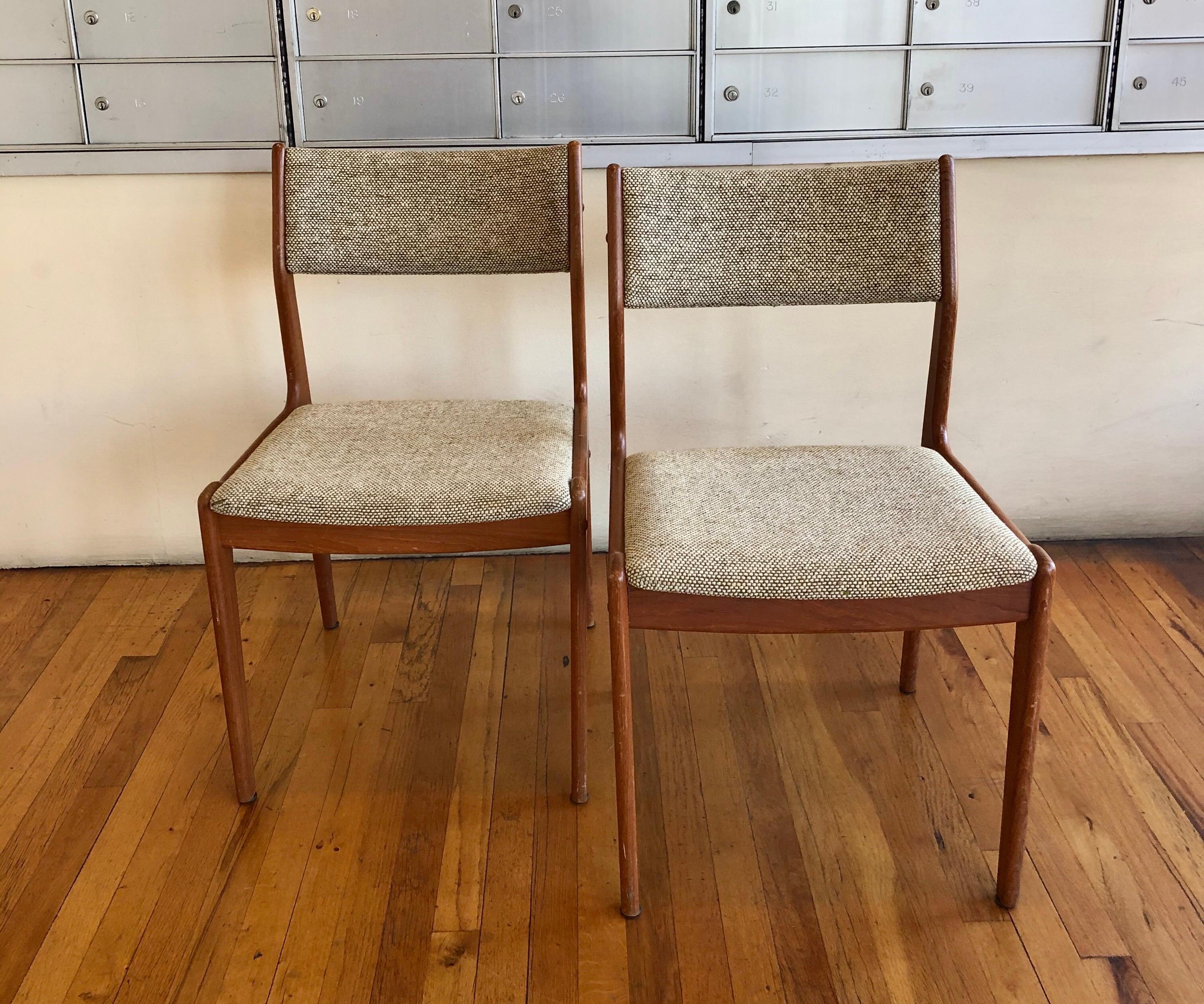 Nice pair of solid teak dining chairs original upholstery seats, in oatmeal color. Made in Denmark, circa 1960s.