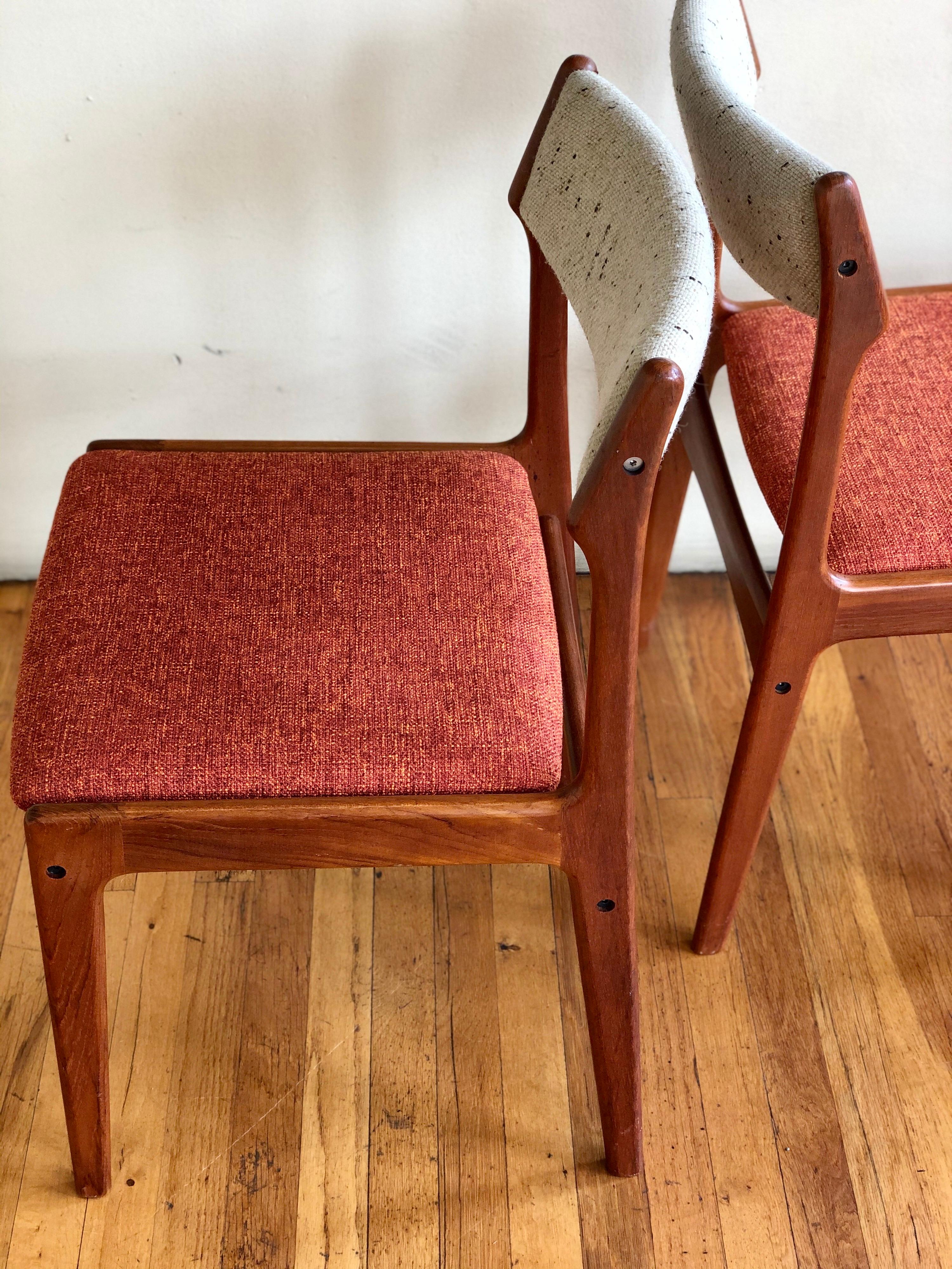 Nice pair of solid teak dining chairs freshly new upholstery seats, in orange with oatmeal back. Made in Denmark, circa 1960s.