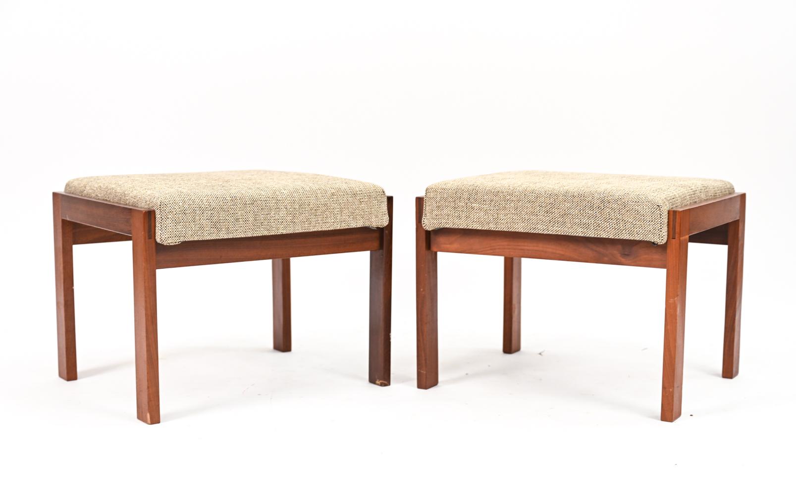 A stylish pair of Danish mid-century footstools or ottomans in handsomely grained teak with new finely checkered knit fabric in neutral earth tones. These Scandinavian modern stools are in the manner of Illum Wikkelso and Kai Kristiansen's