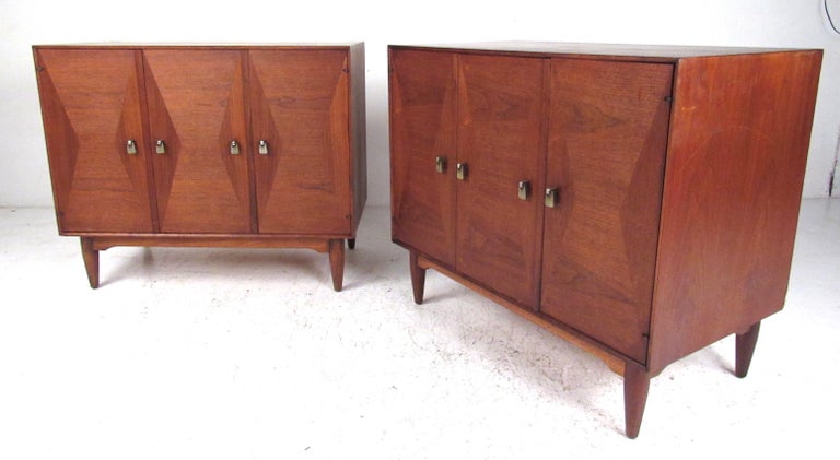 Vintage Scandinavian teak veneered cabinets with diamond pattern fronts, bi-fold doors, and drop pull hardware. Great storage possibilities as lamp tables in the living room, office, or as nightstands the bedroom. Please confirm item location (NY or