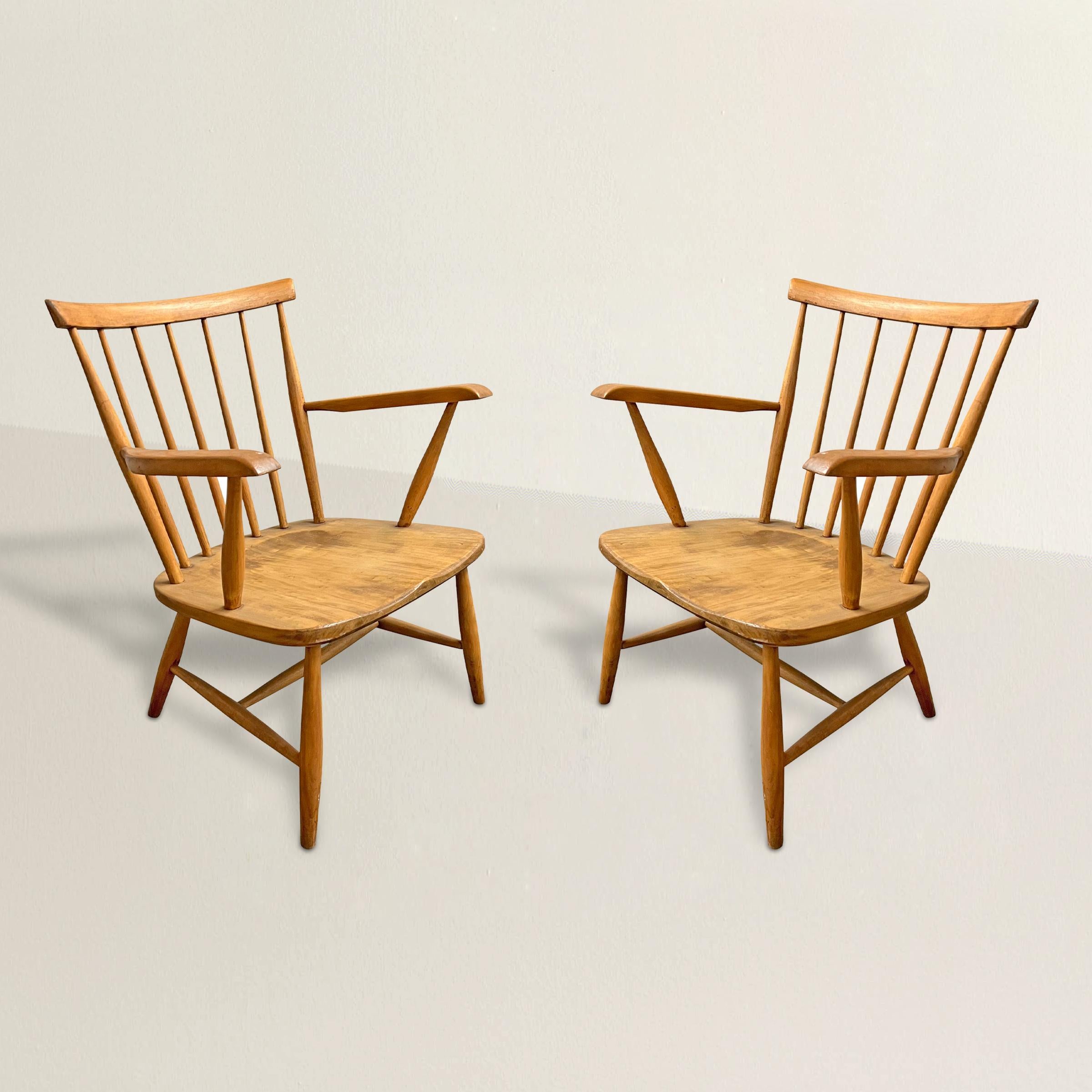 Experience the timeless beauty and innovative design of these mid-20th century Danish Modern beech wood armchairs. Rooted in traditional Windsor chair design, these chairs seamlessly blend the best of classic and contemporary aesthetics. With their