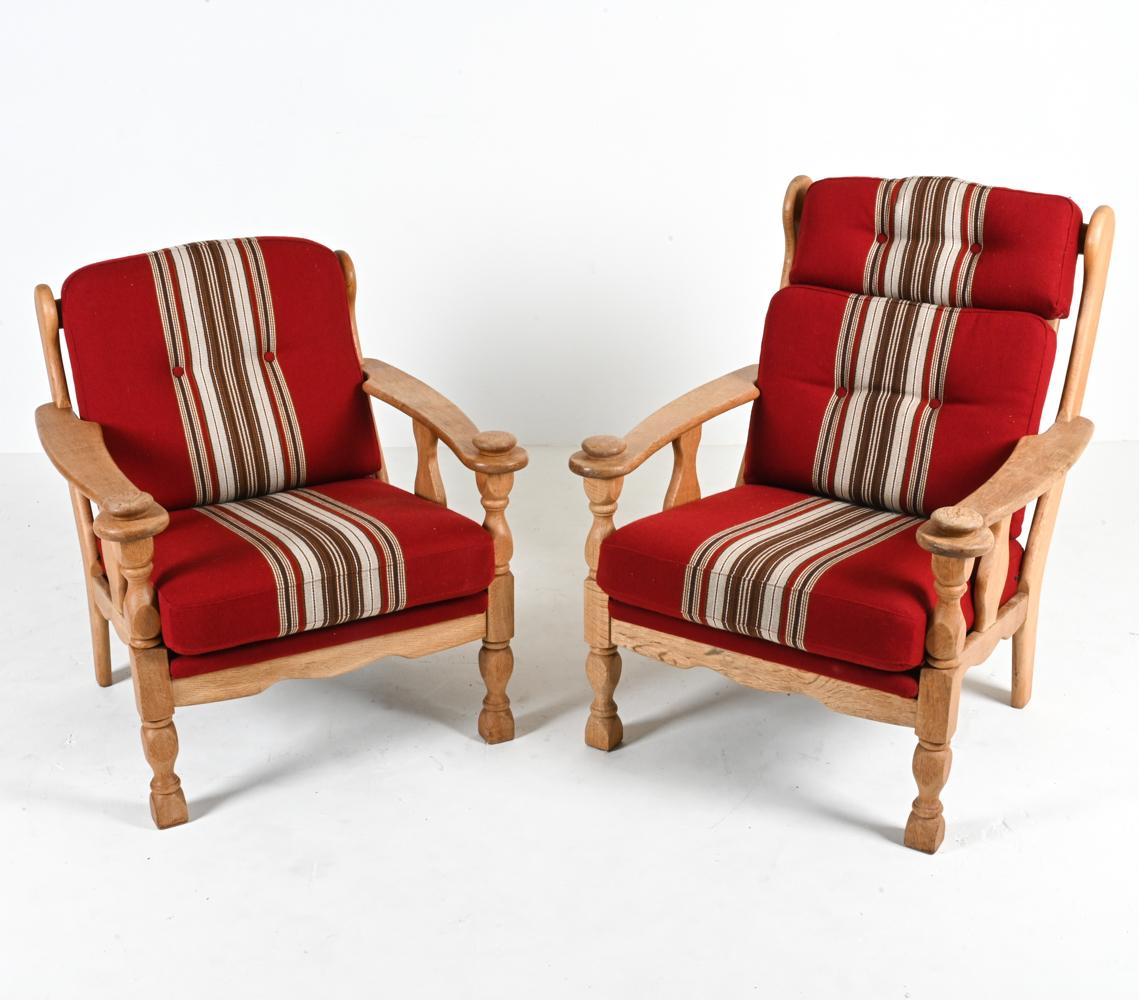 Capture the spirit of the 1970's with this fabulous pair of chairs attributed to Henning Kjærnulf. Crafted from quarter-sawn white oak, the frames feature slatted backs with subtle winged stiles and sculpted handrests that offer a pleasing tactile