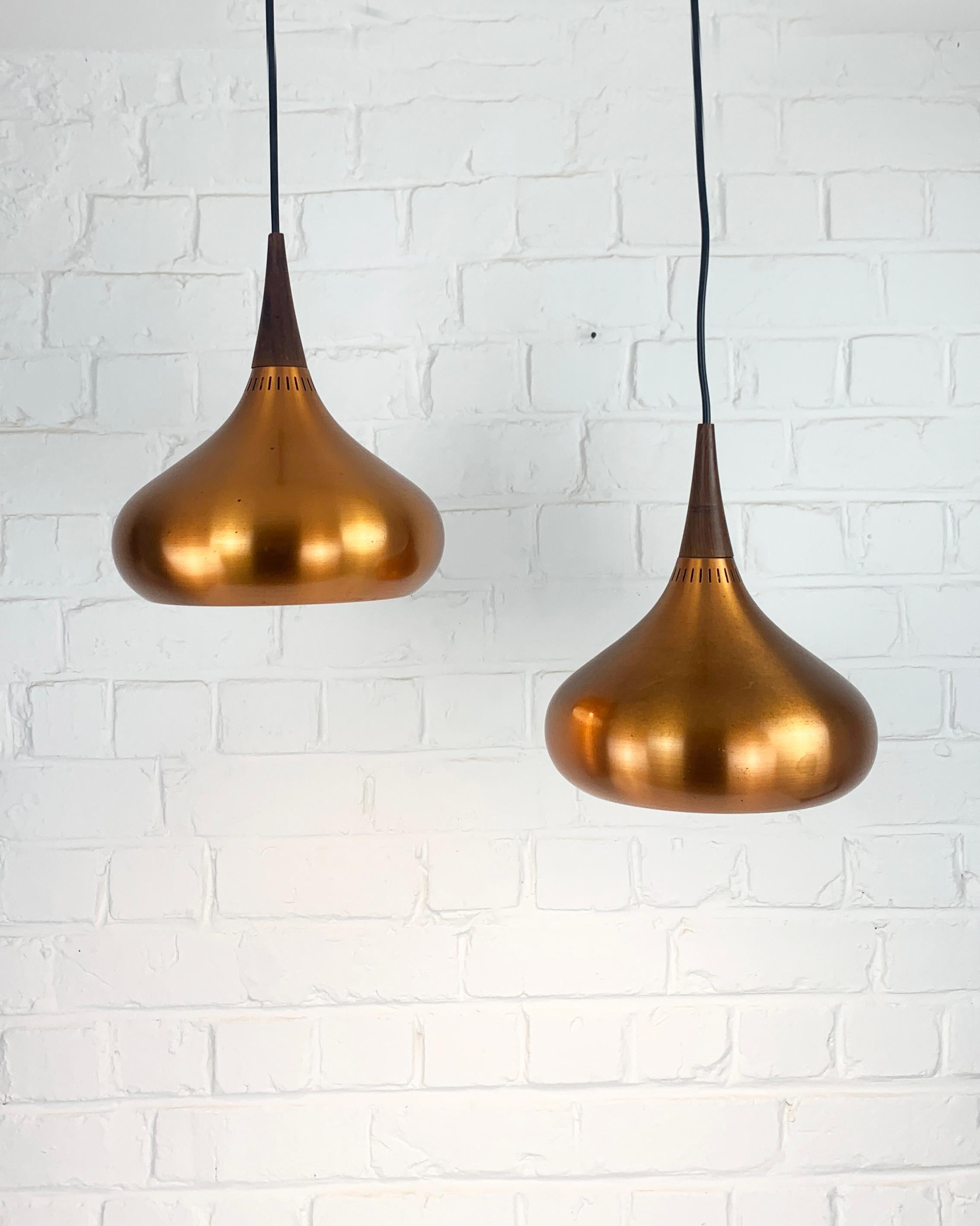Pair of Orient Minor pendant lamps in brushed copper. Design by Jo Hammerborg in 1957 for Fog & Morup, Denmark. 

Jo Hammerborg has been the art director of Fog & Morup for over 20 years. He designed a multitude of models, including the Orient