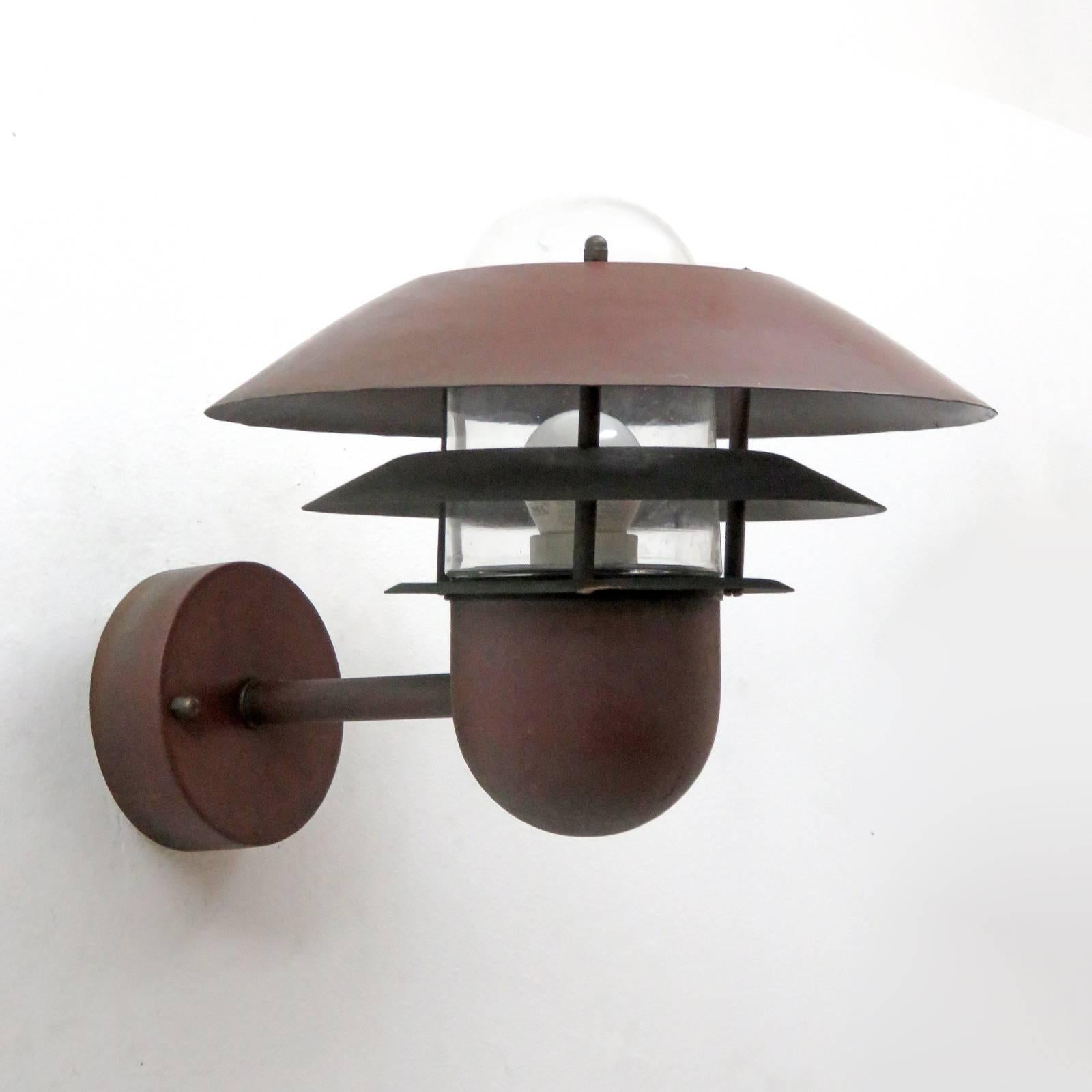 Great pair of Danish outdoor wall sconces by Nordlux in copper with glass bulb enclosures.