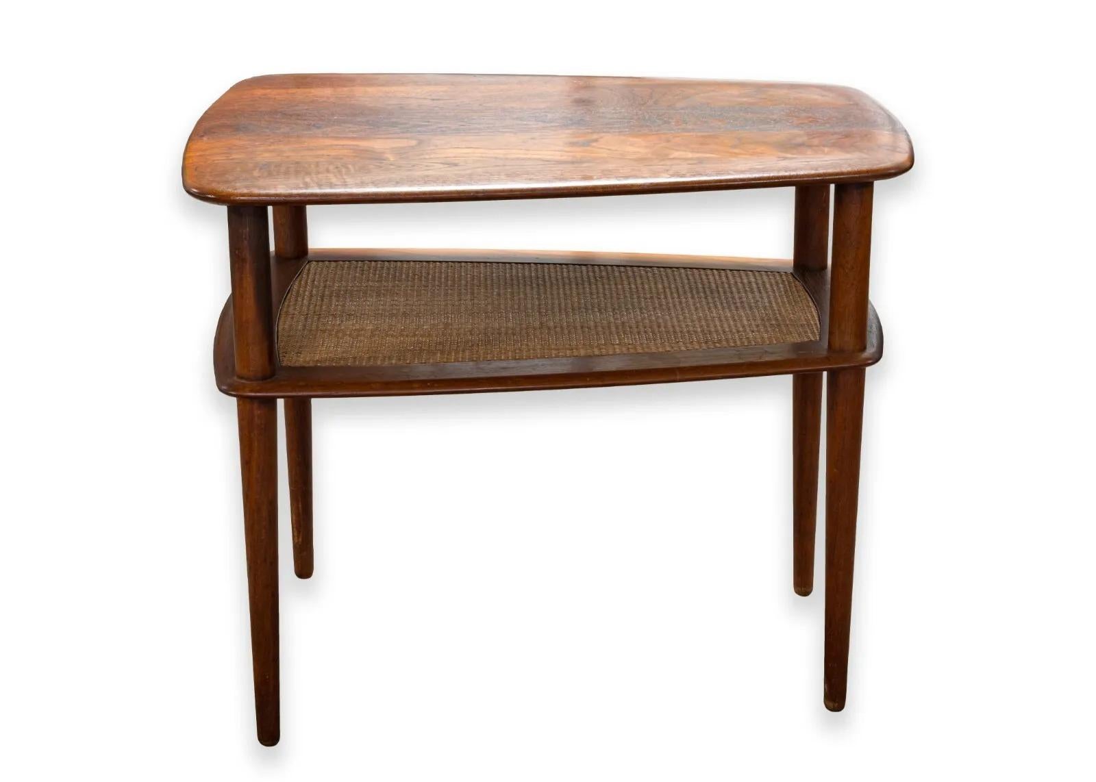 A pair of Danish Peter Hvidt for John Stuart side end tables. A super cool set of matching mid century modern tables. This set of tables feature a beautiful wood construction. The wood color is rich and the grain on the table top is gorgeous. These