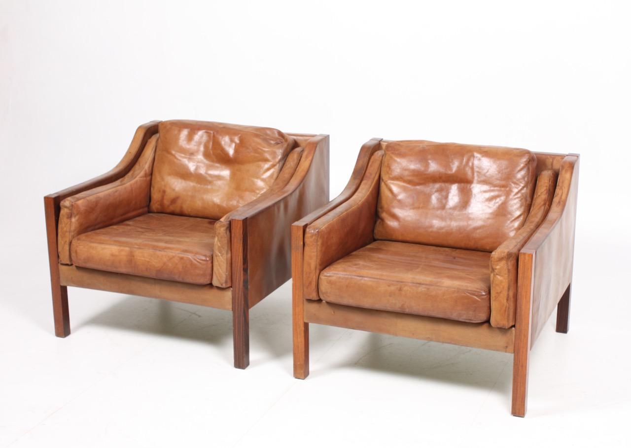 Pair of well patinated leather lounge chairs designed by Poul Volther for Erik Jørgensen in the 1960s. Made in Denmark. Good original condition.