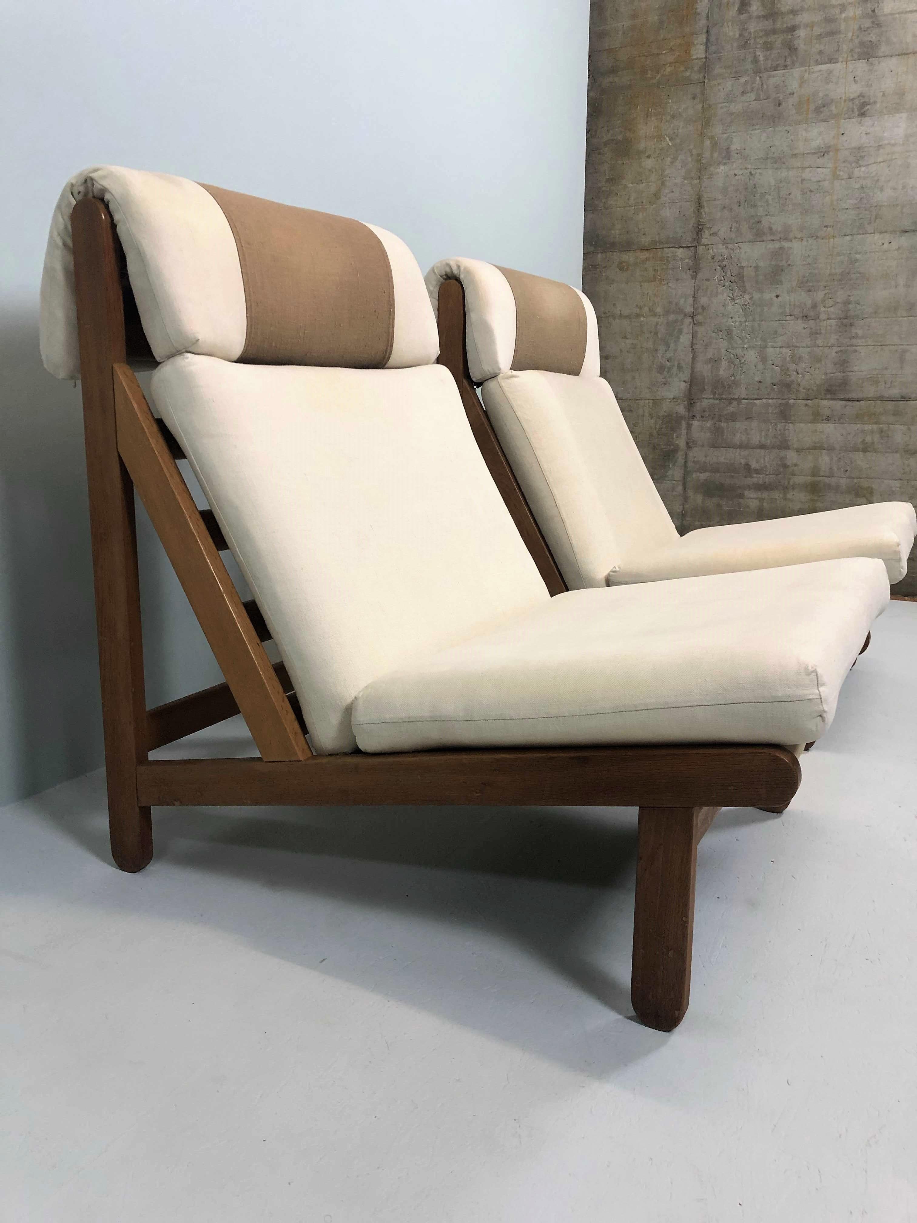 Rare and very sought after pair of easy lounge chair designed by Bernt Petersen for Schiang Furniture of Denmark in 1966. Collection Fuglsang. Marked. Oak frames with loose cushions in seat and back upholstered with an off-white colored heavy