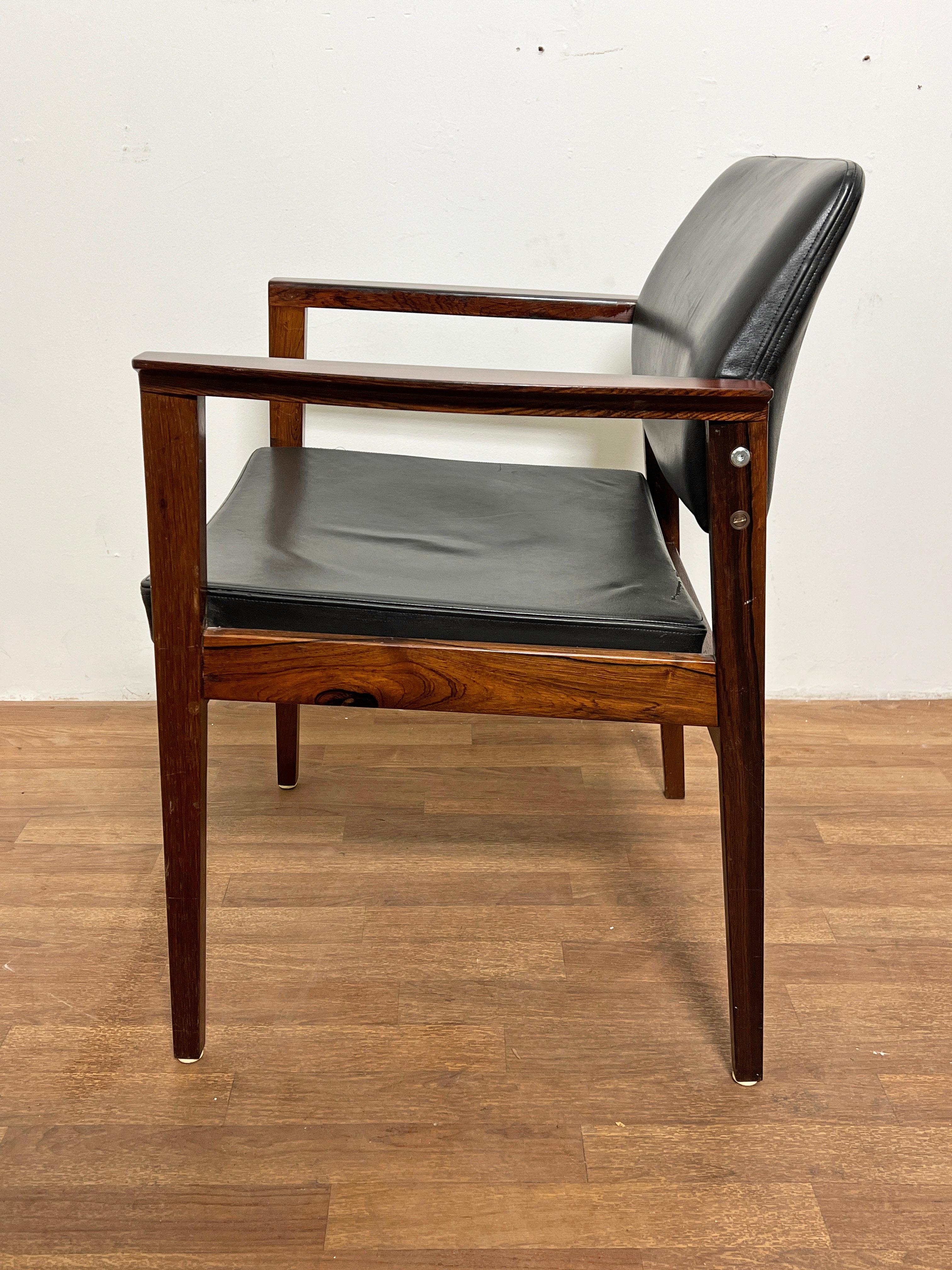 Pair of arm chairs in rosewood with leather upholstery. Unmarked, but most likely Danish, and most certainly of Scandinavian origin.