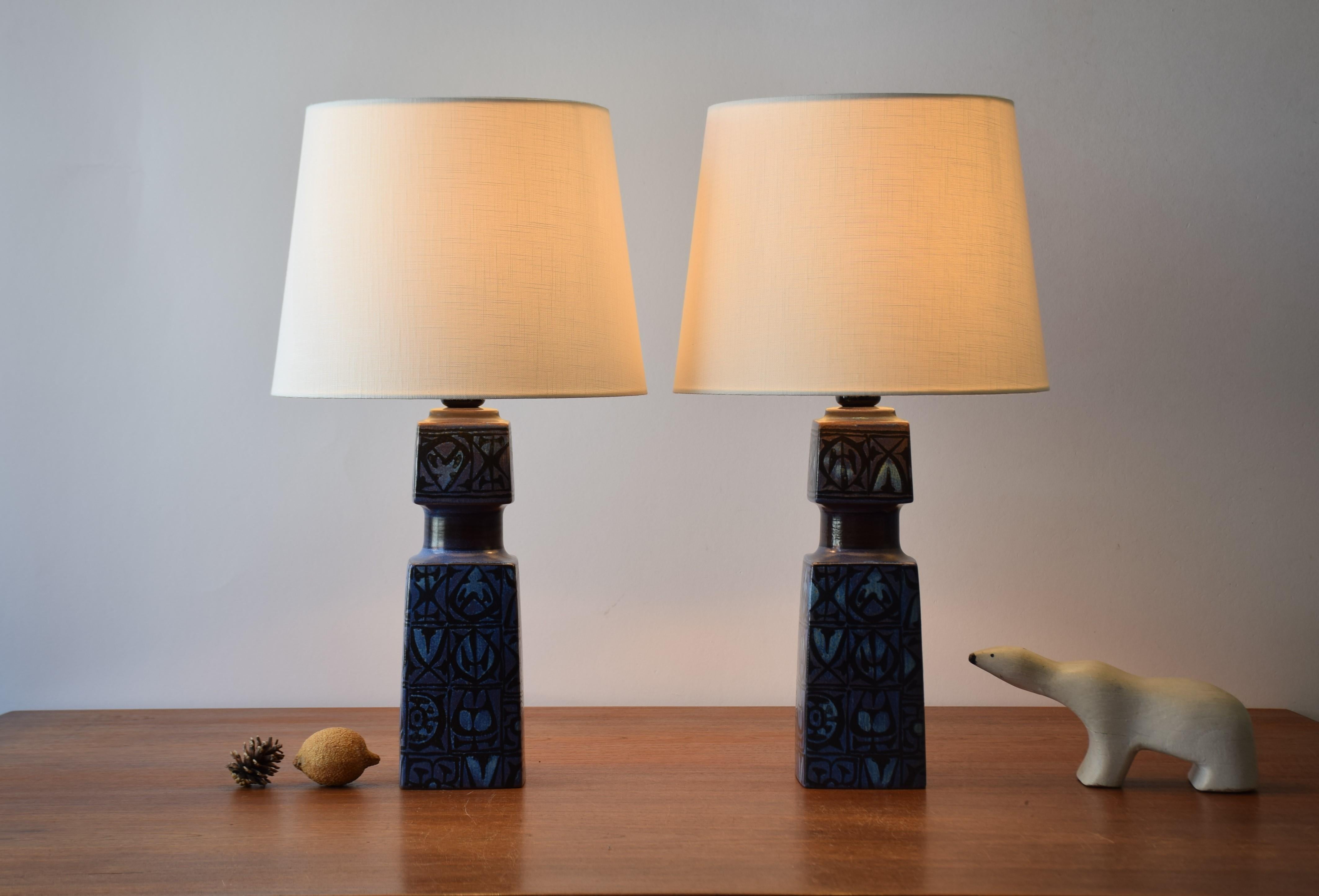 Pair of table lamps designed by Nils Thorsson for Royal Copenhagen and Fog & Mørup and made, circa 1970s.
They have a tactile abstract decor with black on dark blue.
The lamps are the larger version of this series.

Included is a set of new