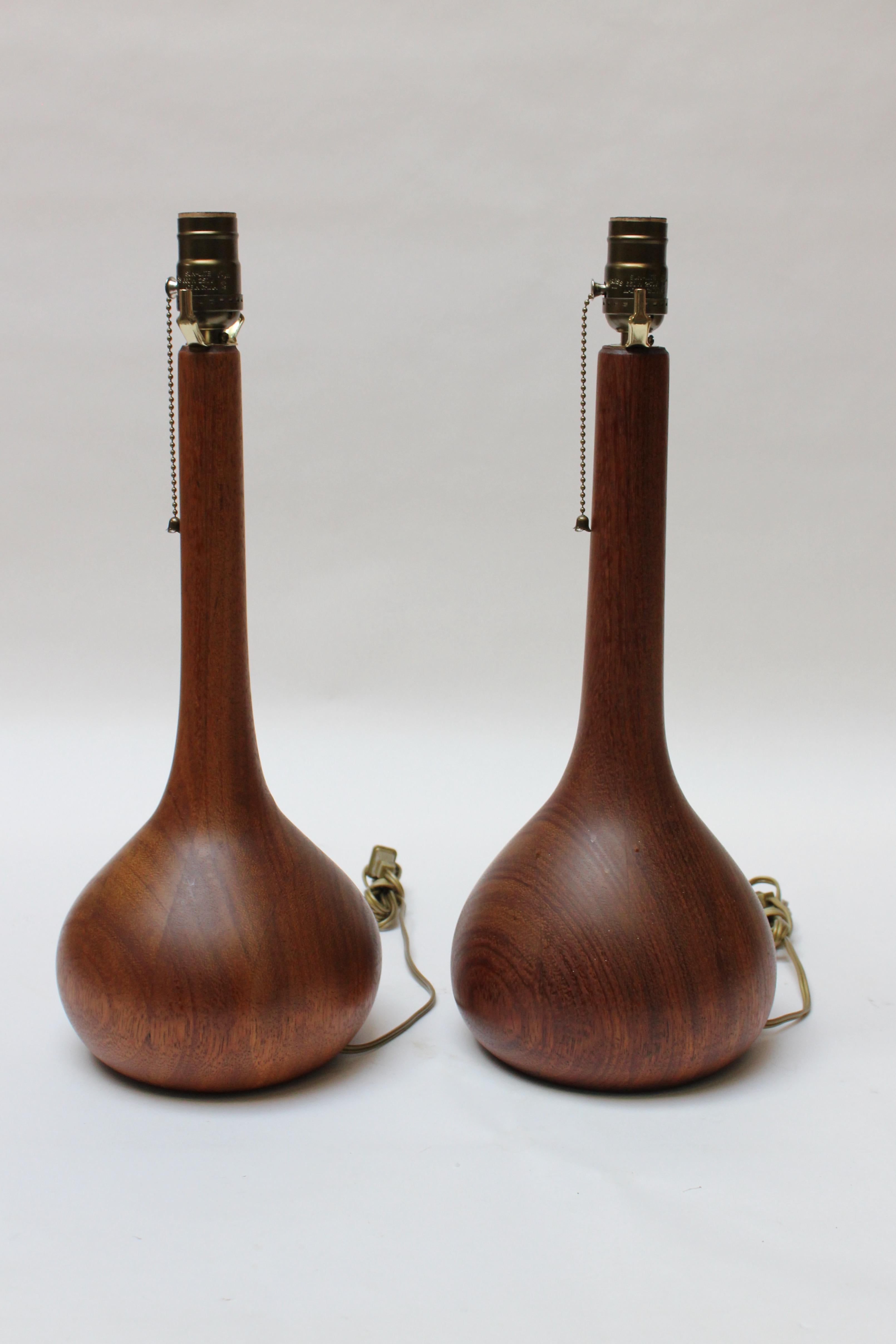 Sculptural bulbous-form table lamps in solid staved-teakwood (ca. 1960s, Denmark). Vivid grain and rich color with new sockets / wiring and added 