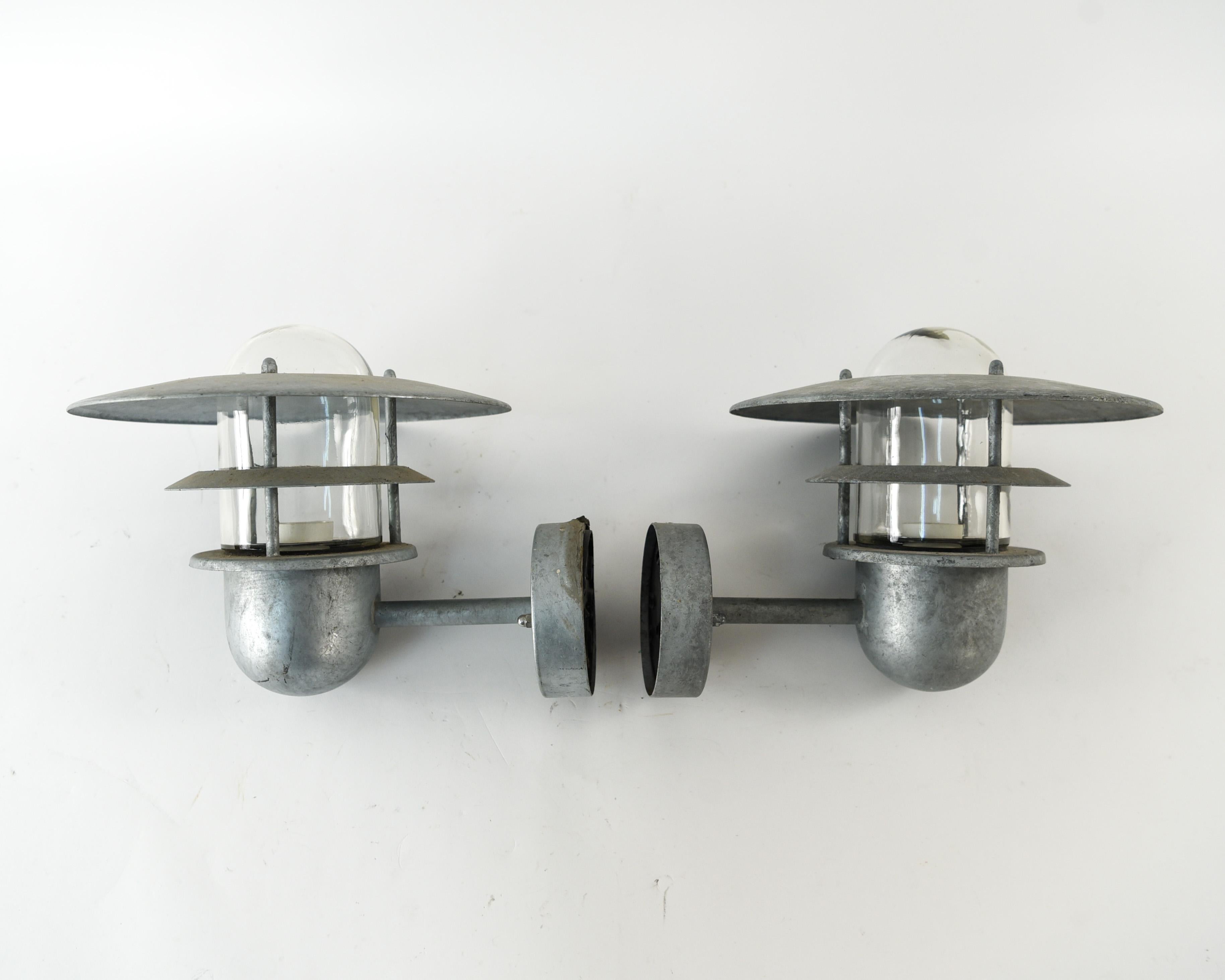 This is an attractive pair of Danish outdoor sconces. This pair is made of steel which helps with weather resistance. This is a great way to incorporate Scandinavian modern design to an exterior of a home, perhaps on either side of the door.
