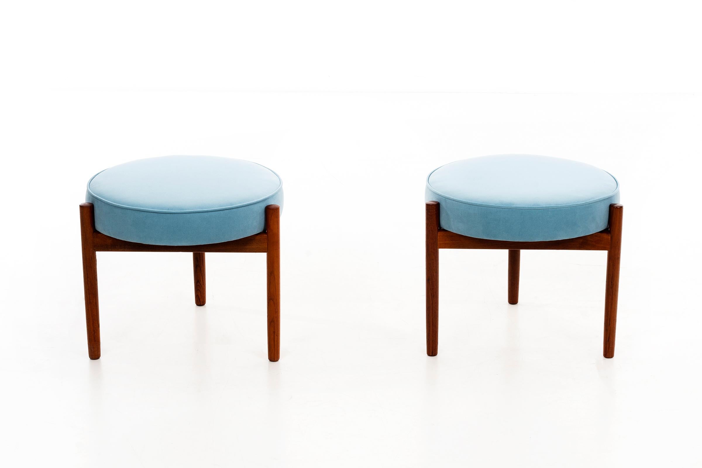 Pair of oiled walnut 3-legged stools with blue ultra suede seat cushions newly upholstered.
Danish labels on underside.