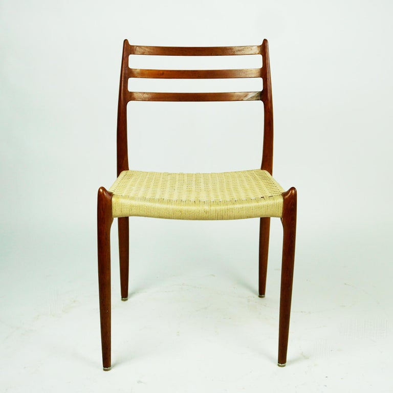 Iconic Danish modern Pair of teak dining chairs Mod. 78 with Textile cord seats designed by Niels Otto Moller in 1962 and produced by J.L. Mollers Mobelfabrik in Denmark. Early production in very good original Condition, seats with some wear due to