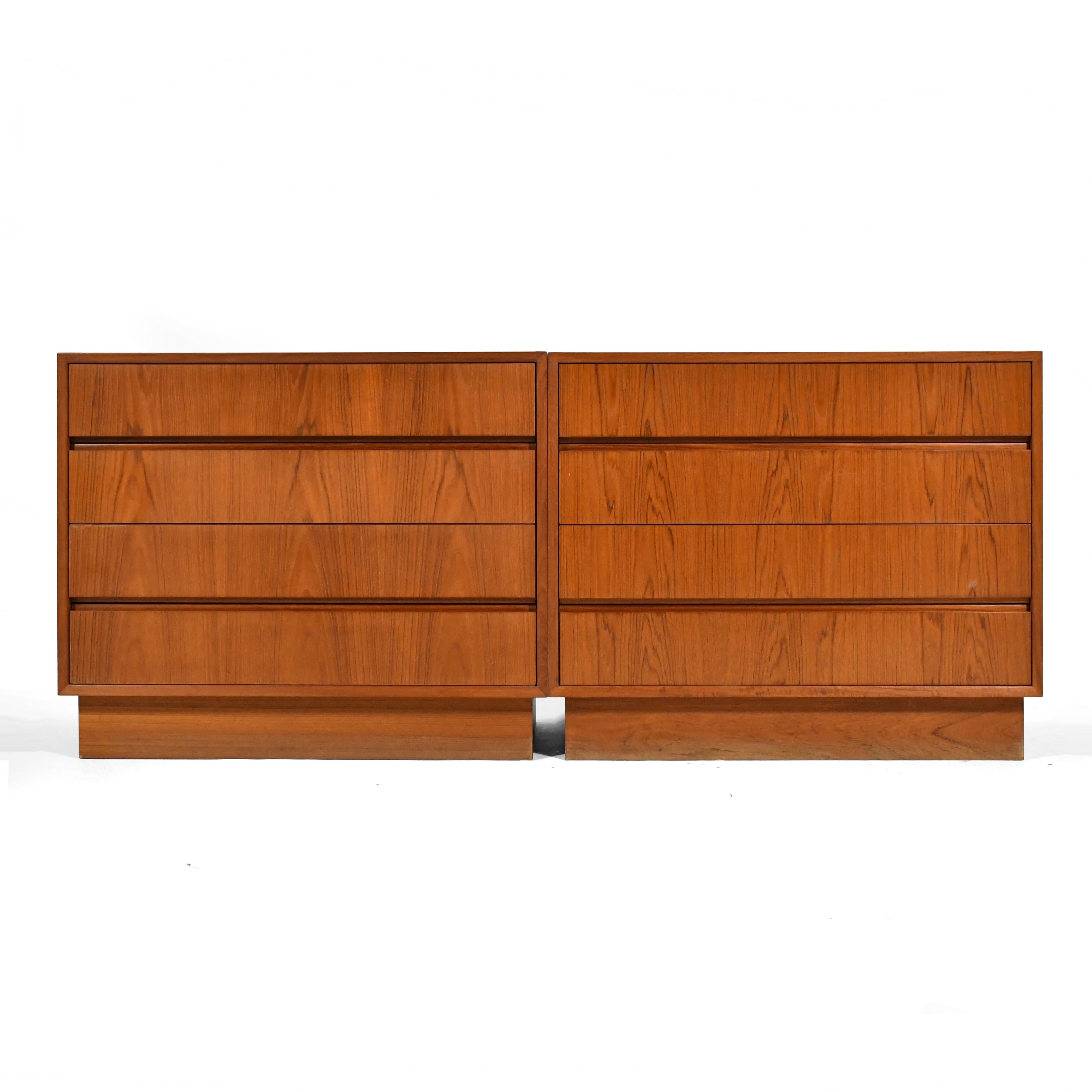 These two teak four drawer dressers can be used independently or in tandem to create one long dresser. Clad in beautifully figured wood, with integrated pulls, they are a study in subtle beauty. Price is for the pair.

Measures: 29.75