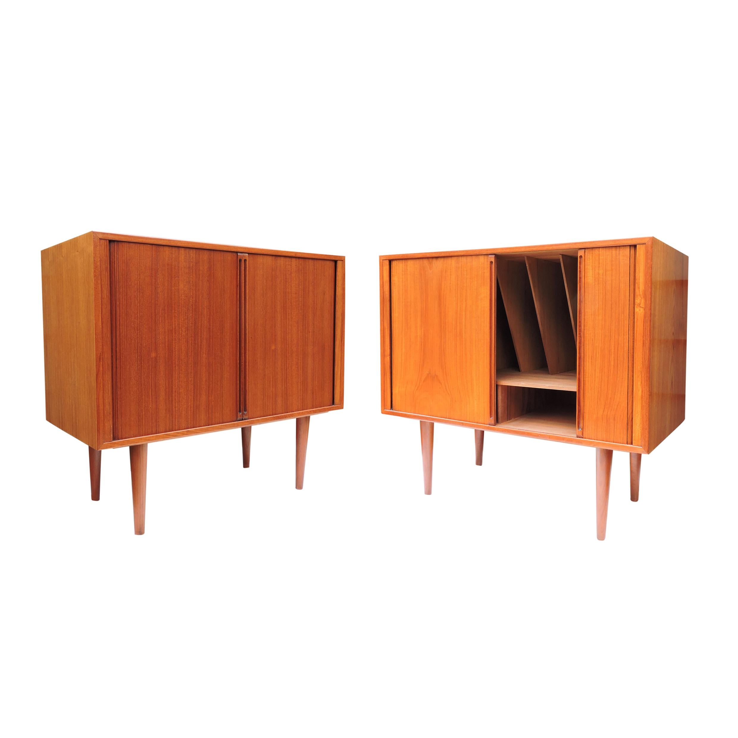A pair of teak tambour door record cabinets by Kai Kristiansen for Feldballes Mobelfabrik, Denmark, 1960s. There is divided space within, for records or books with two lower shelves.
 
