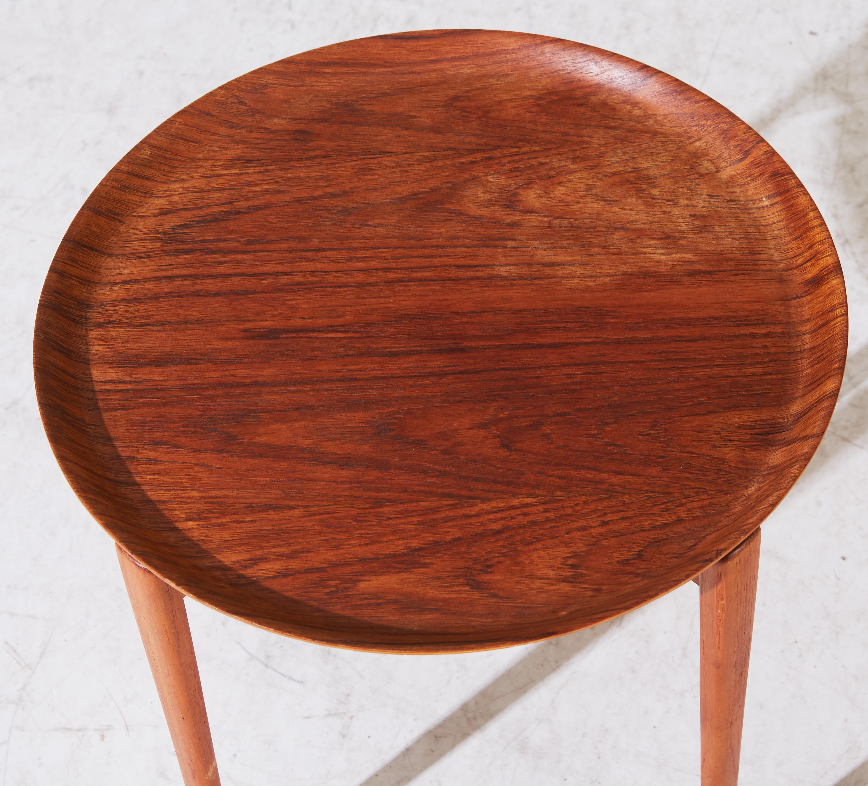 This pair of end tables in solid teak are made by Viskadalens Mobelindustri, Denmark. The circular removable tops sit of X-shape supports. Each are stamped with marker's marks
