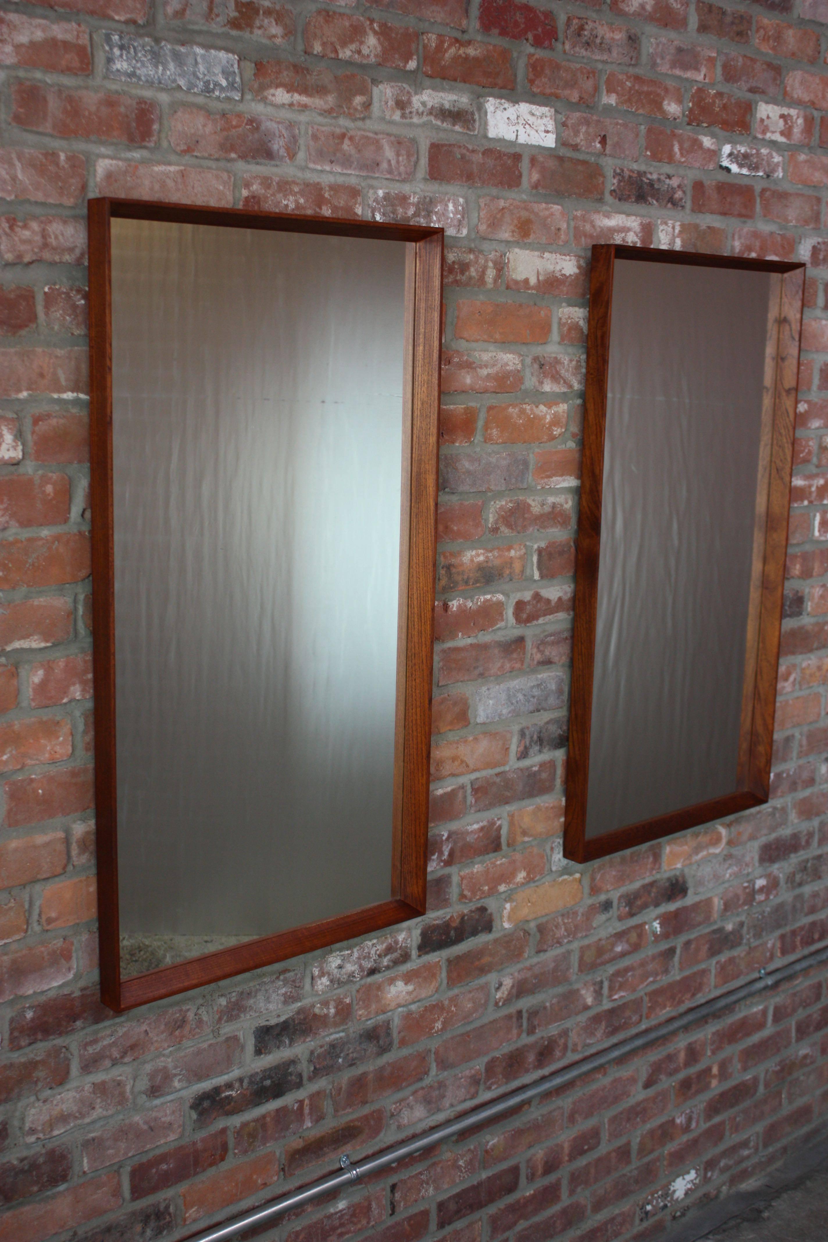 Nice pair of 1960s Danish Modern teak-framed mirrors by Pedersen & Hansen. 
Beautiful, refinished condition. Mirrors themselves are clean, with no issues. 
Sold as a pair.
