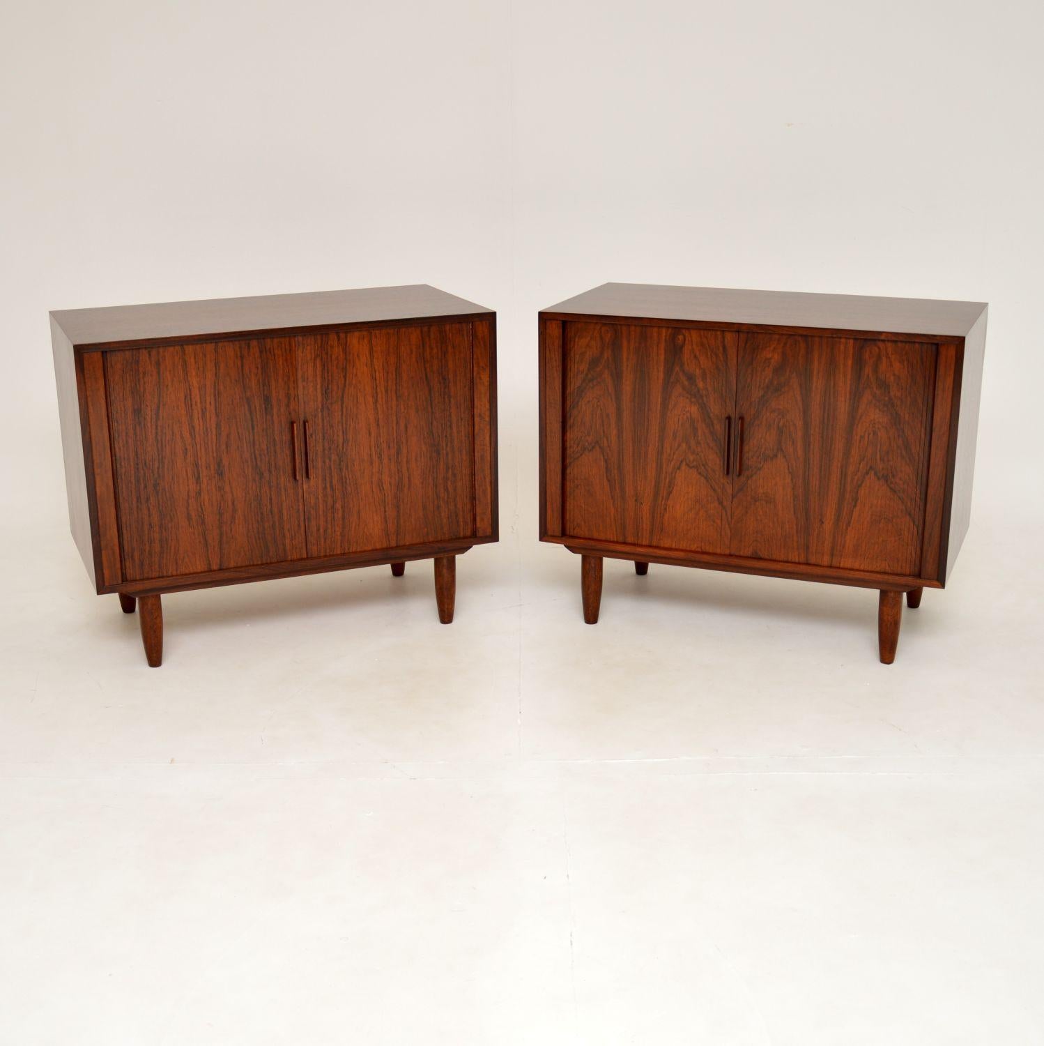 A stunning and rare pair of Danish vintage tambour front cabinets. These were designed by Kai Kristiansen, they were made in Denmark in the 1960’s.

The quality is superb, these have a gorgeous and clever design. The tambour door fronts roll back