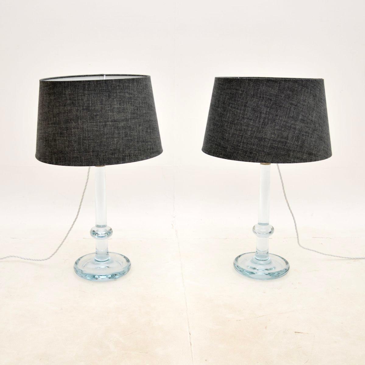 A stunning pair of Danish vintage glass table lamps by Michael Bang for Holmegaard. They were made in Denmark, they date from around the 1960-70’s.

The quality is superb and they are beautifully designed. The clear glass stands have a very slightly