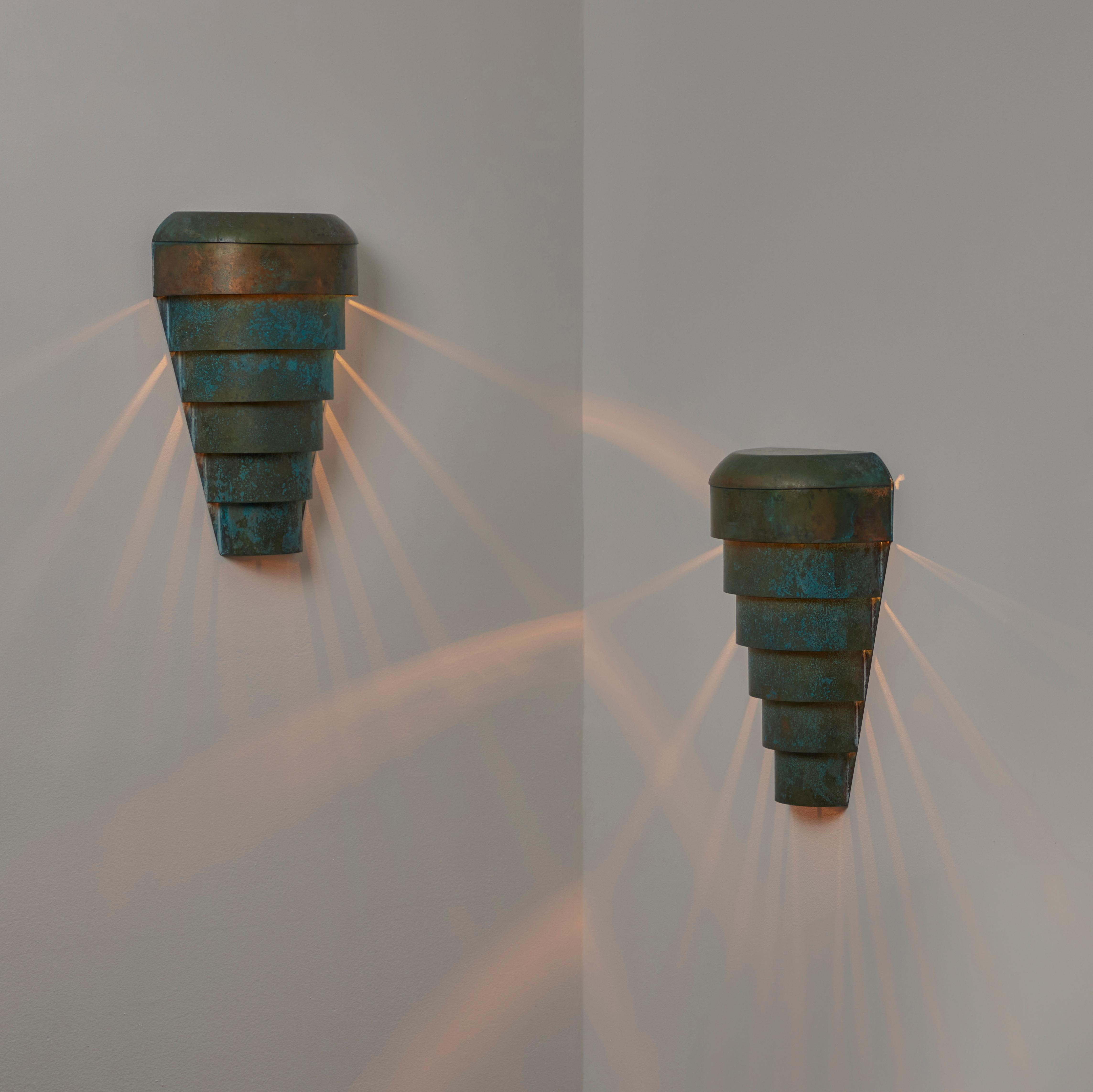 Pair of Danish Wall Lamps. Designed and manufactured in Denmark in the 1940s. Triangular copper design with a tiered step-down pattern. Can be installed facing down or facing up. Verde color finish throughout. Holds a single e27 socket type, adapted