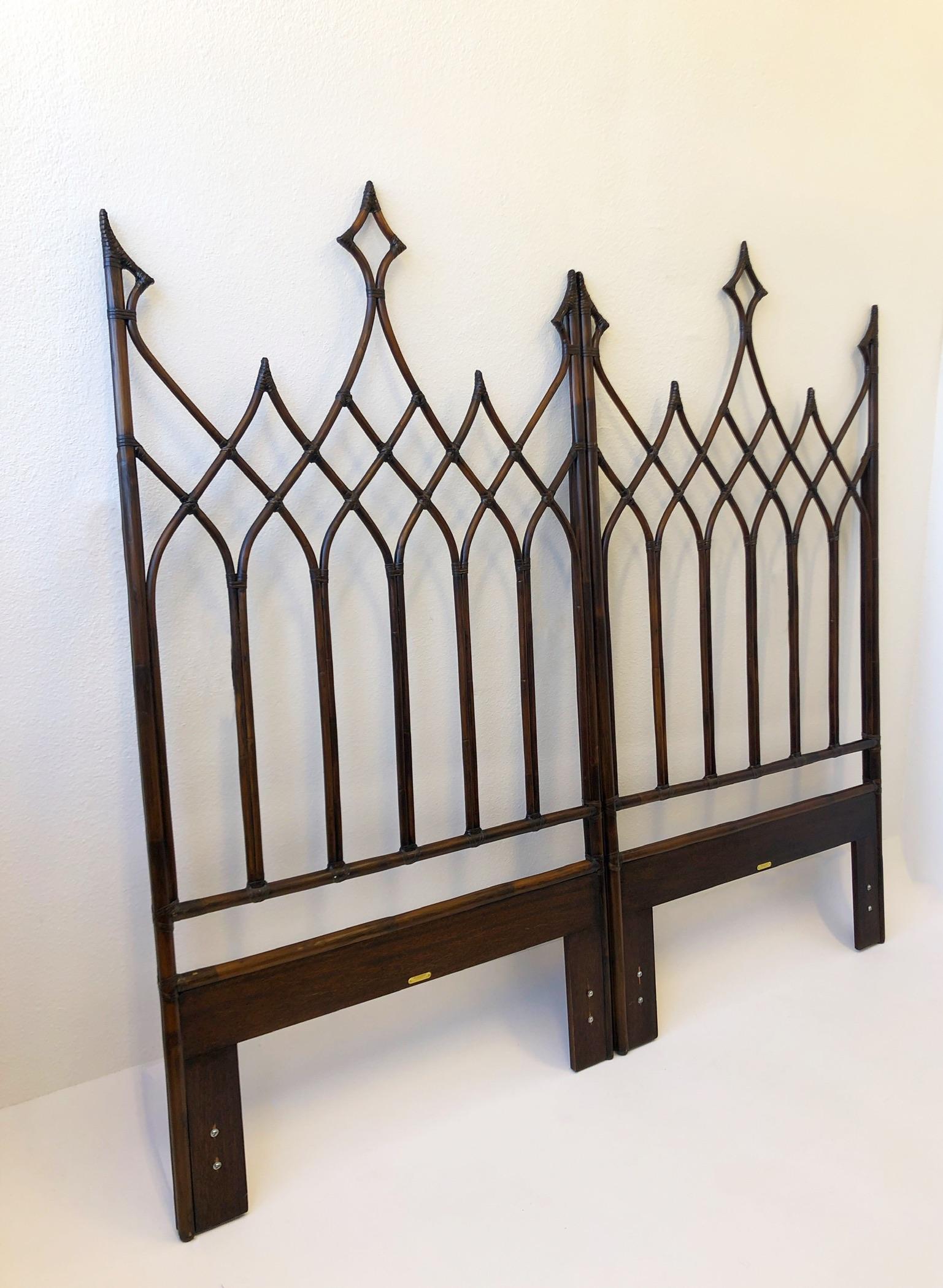 1970s pair of Gothic Revival twin headboards by McGuire of San Francisco. 
Constructed of Bamboo and rawhide finished with a dark stain. 
Excellent vintage condition. 
Measurements: 41.75” Wide, 2.25” Deep and 77” High.