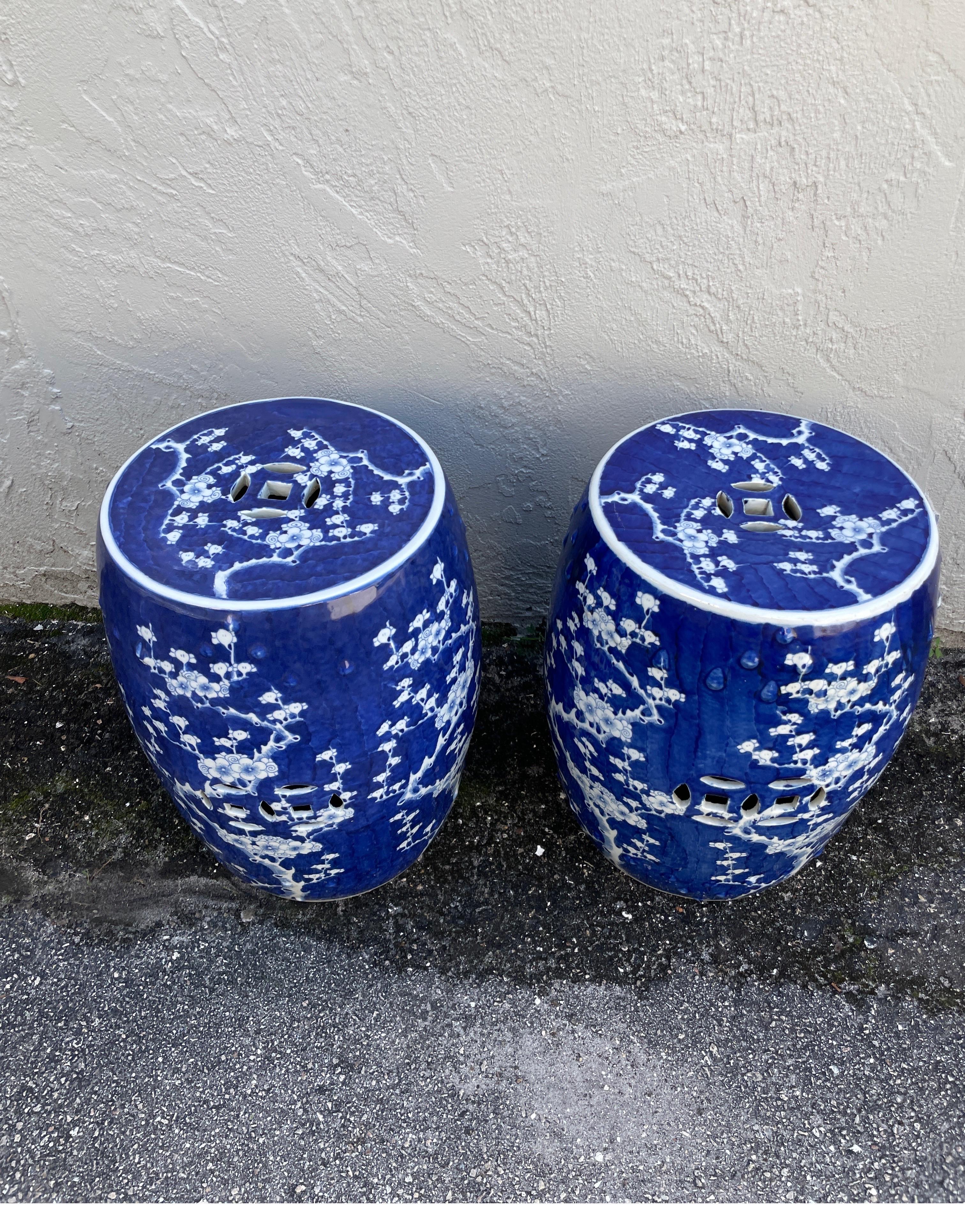 Striking pair of dark blue & white garden seats. The overall white branch & lotus flower design on the rich dark blue background makes these a standout wherever you place them.