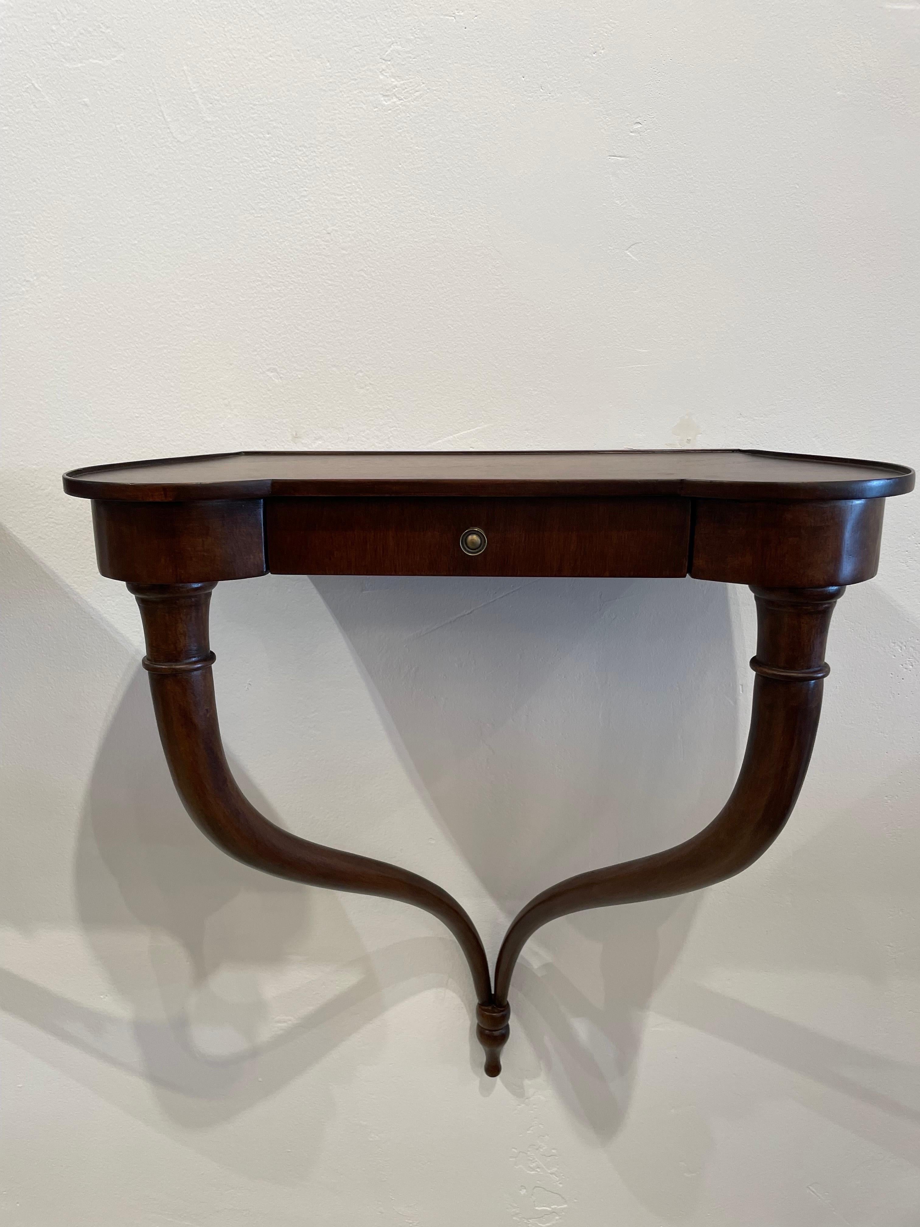 Pair petite Italian 1940's console tables in mahogany, wall mounted shelves or night tables. Elegant vintage Italian serpentine carved mahogany wood wall mounted console tables. Art Deco, in the style of Borsani. The tabletops are uniquely shaped in