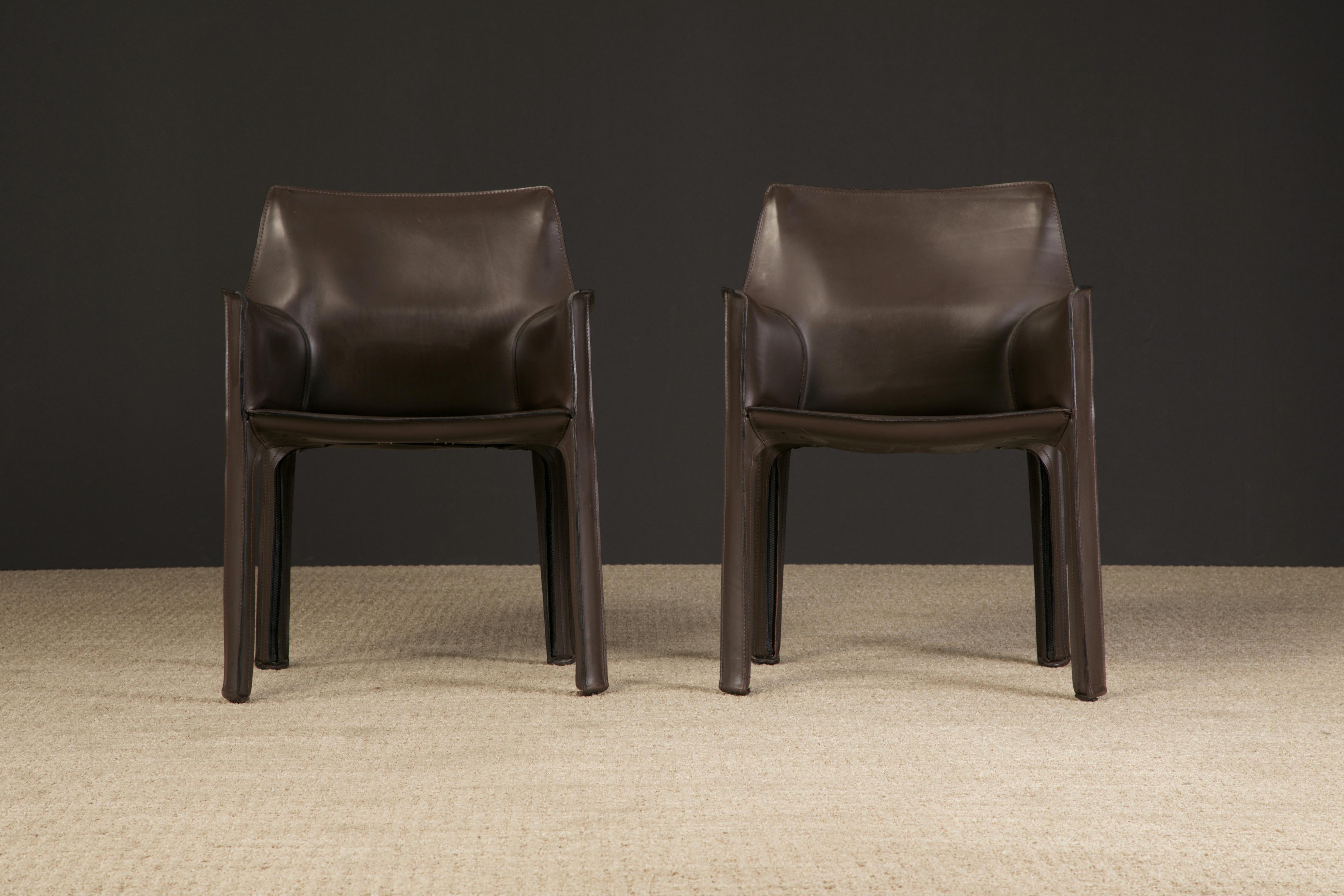 A classy pair of Model #413 'Cab' armchairs in gorgeous deep brown saddle leather by Mario Bellini for Cassina, Italy. Signed underneath seat with Cassina stamp and embossing with model number on the leather. 

Designed in 1977, this beautiful