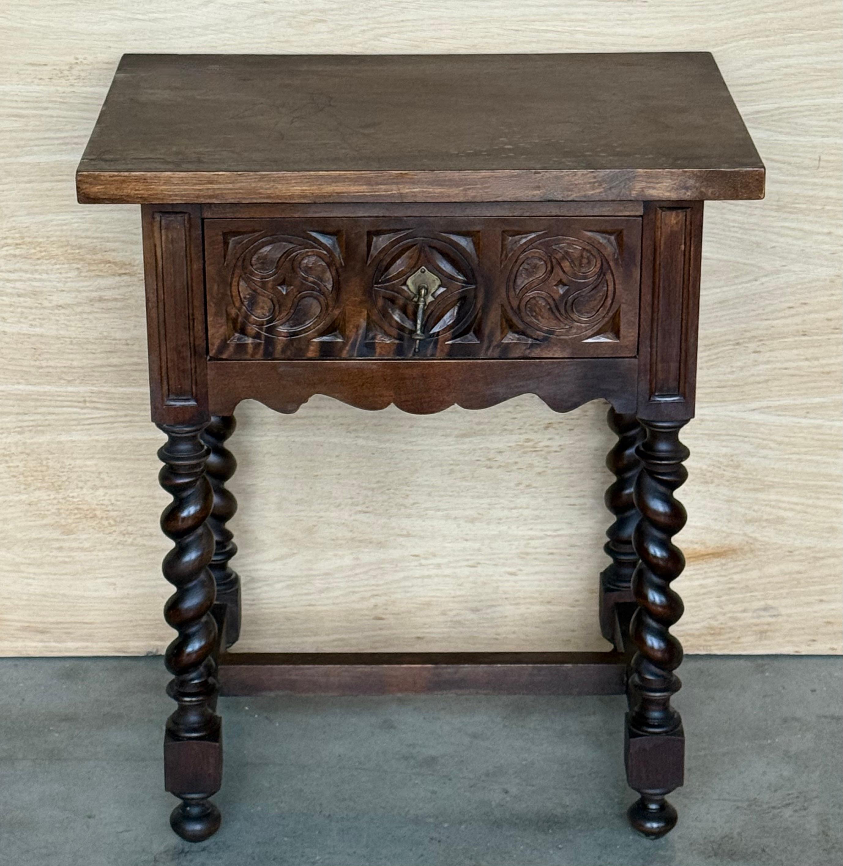 Paire de tables de nuit espagnoles en bois massif sculpté du 20e siècle, avec colonnes solomoniques et tiroirs sculptés en bois ébonisé foncé.
