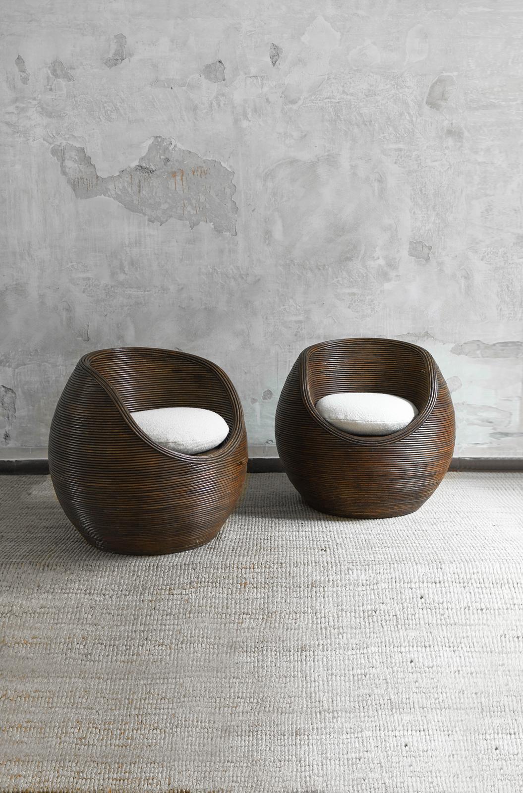 Pair of armchairs covered in bamboo cane in the style of Gabriella Crespi. Circular seat and sphere/egg shape
Complete with Dedar fabric cushions mod. 