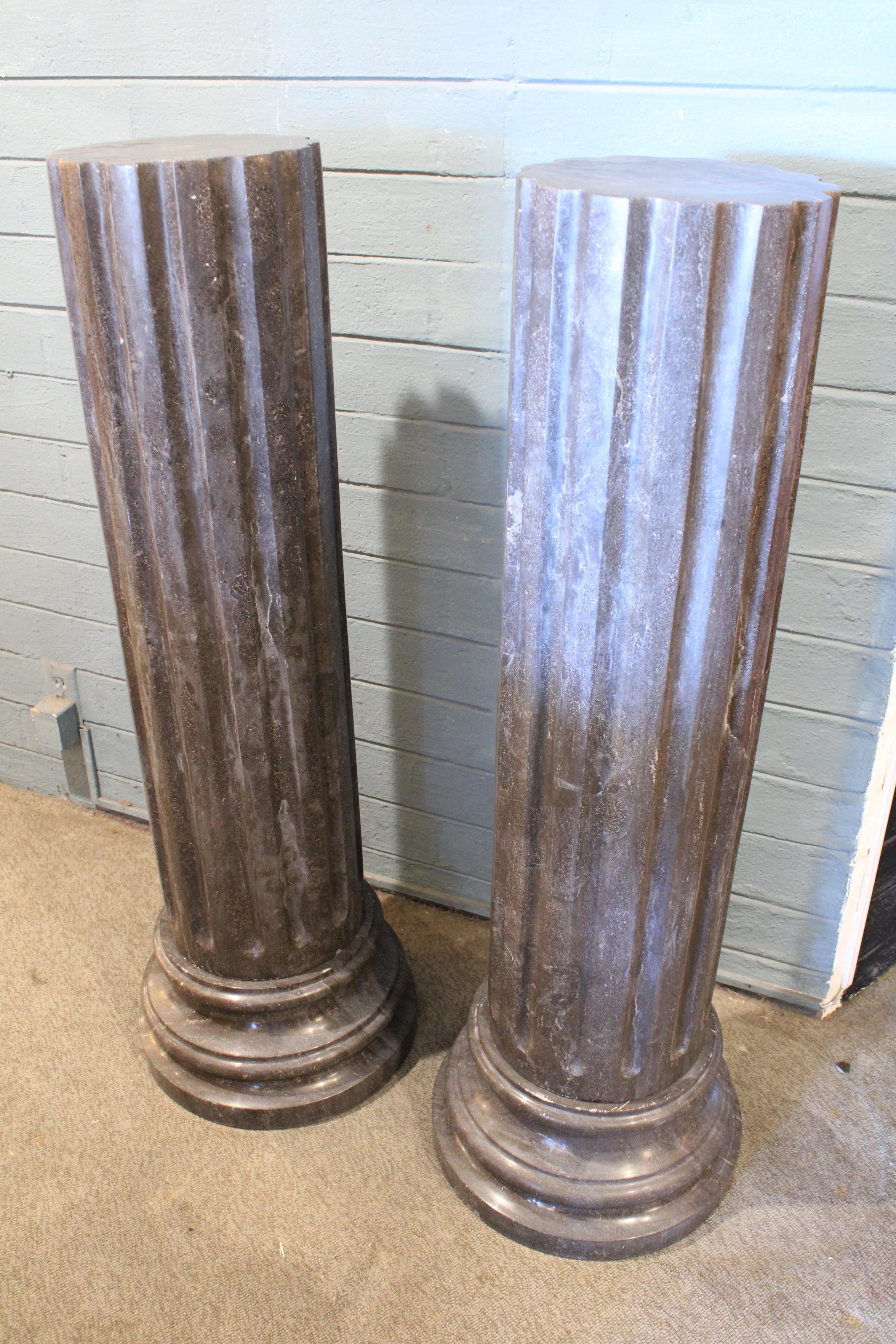 Pair of dark gray fluted marble pedestals resting on circular plinths, circa mid 20th century. Approximate diameter of tops 10