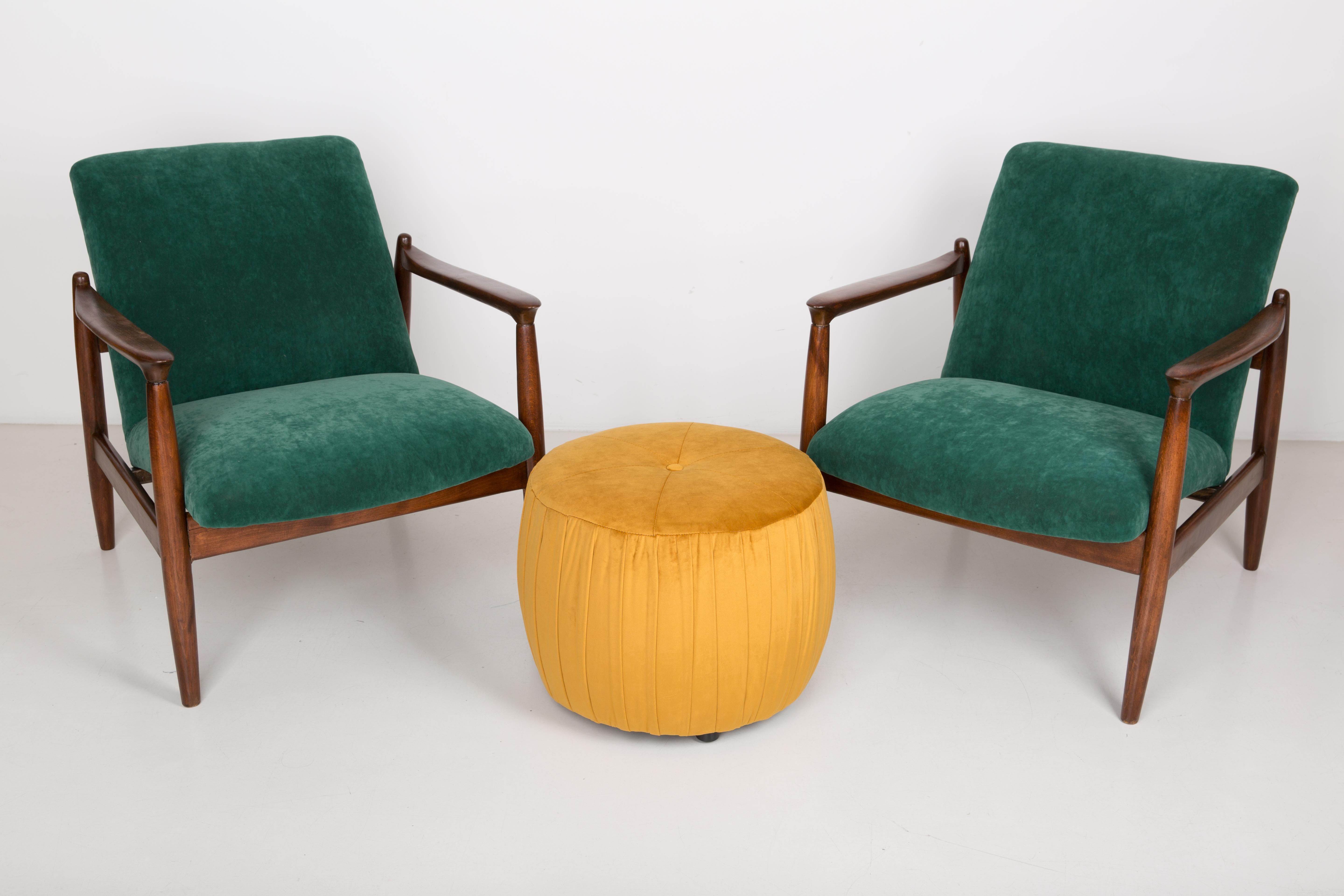 A pair of dark green armchairs, designed by Edmund Homa. The armchairs were made in the 1960s in the Gosciecinska Furniture Factory. They are made from solid beechwood. The GFM type armchair is regarded one of the best polish armchair design from