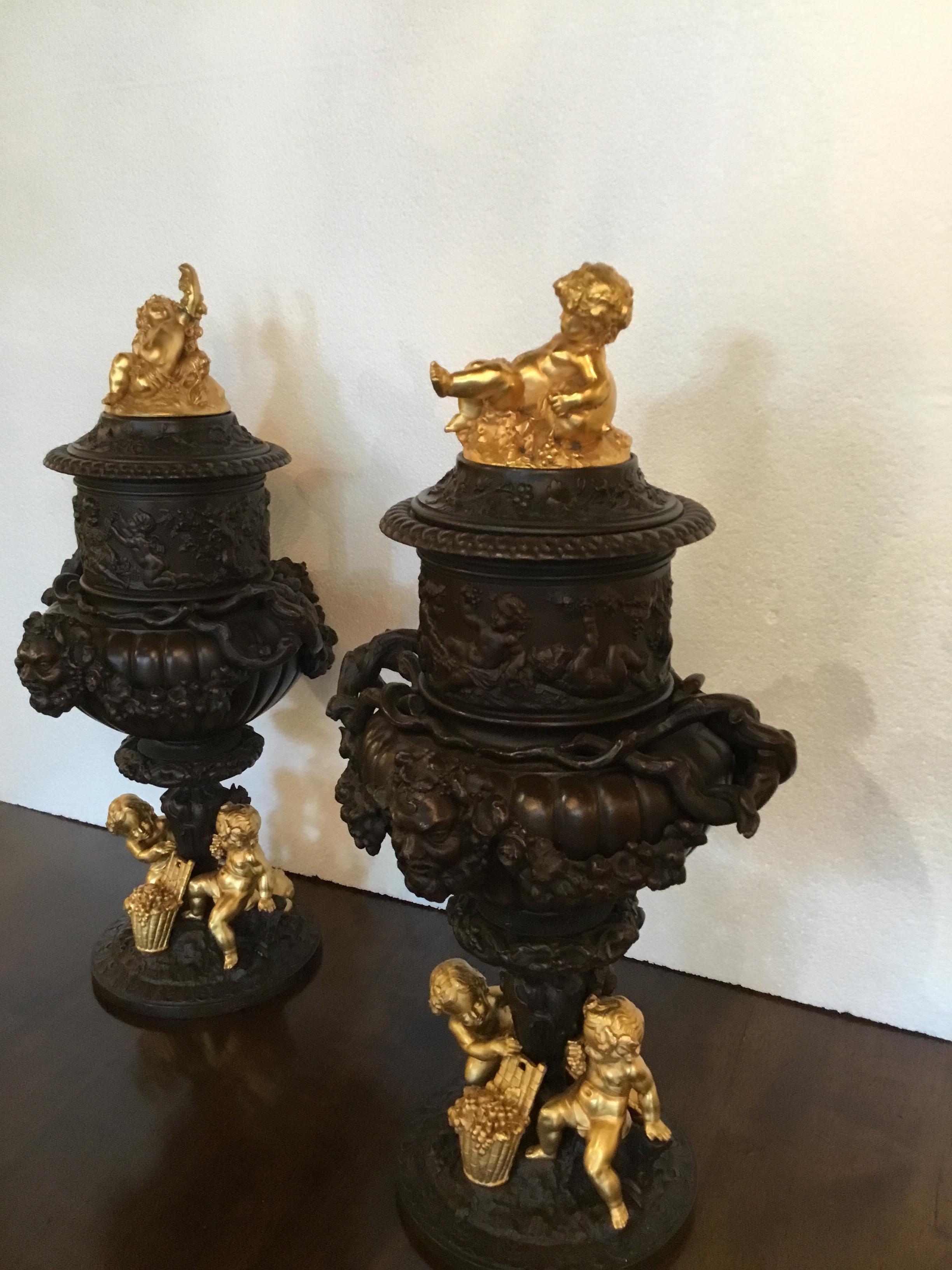 Pair of Dark Patinated Bronze Urns with Gilt Bronze Putti Caps, Baccanal Mask In Good Condition In Houston, TX