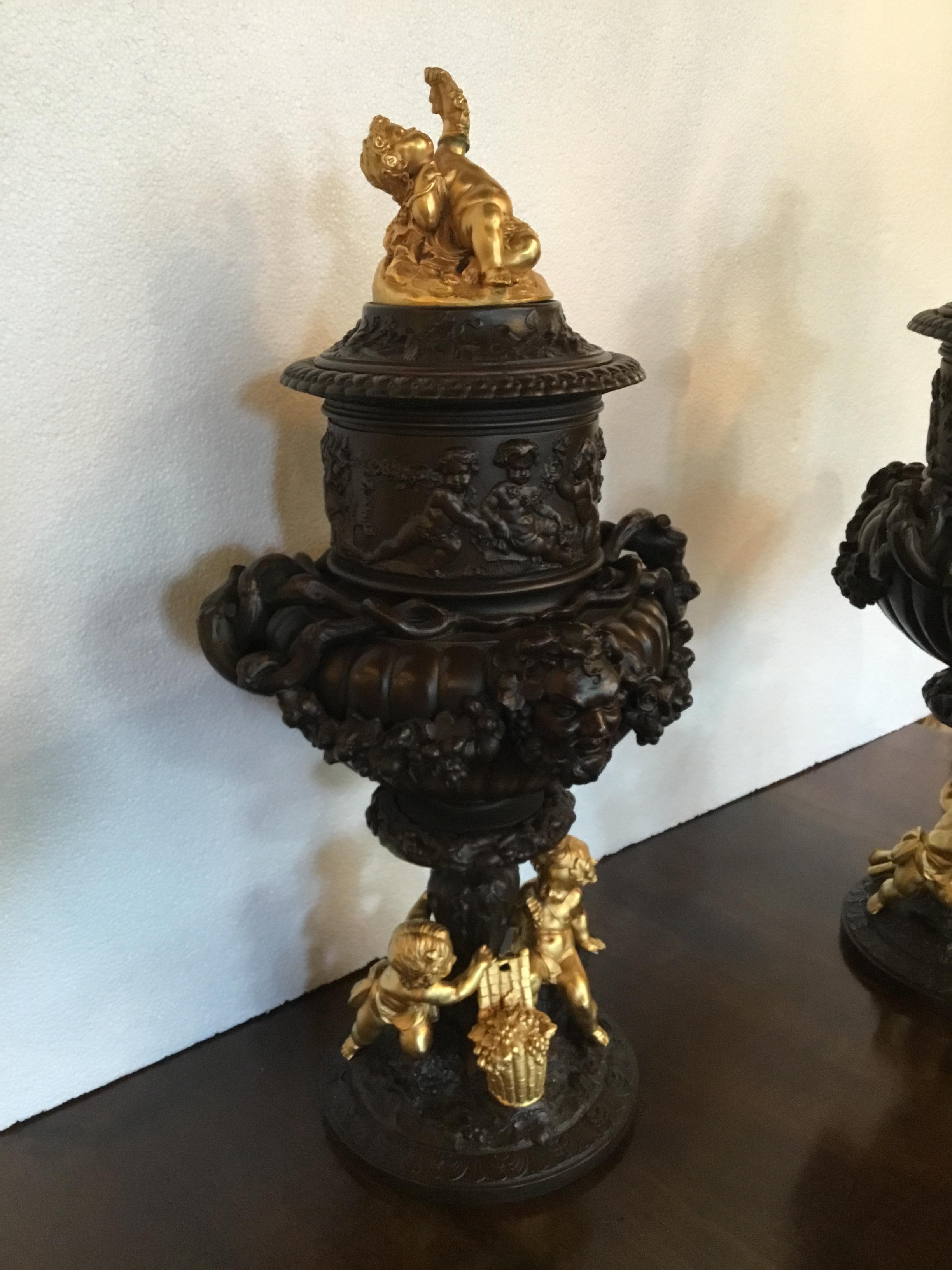 19th Century Pair of Dark Patinated Bronze Urns with Gilt Bronze Putti Caps, Baccanal Mask