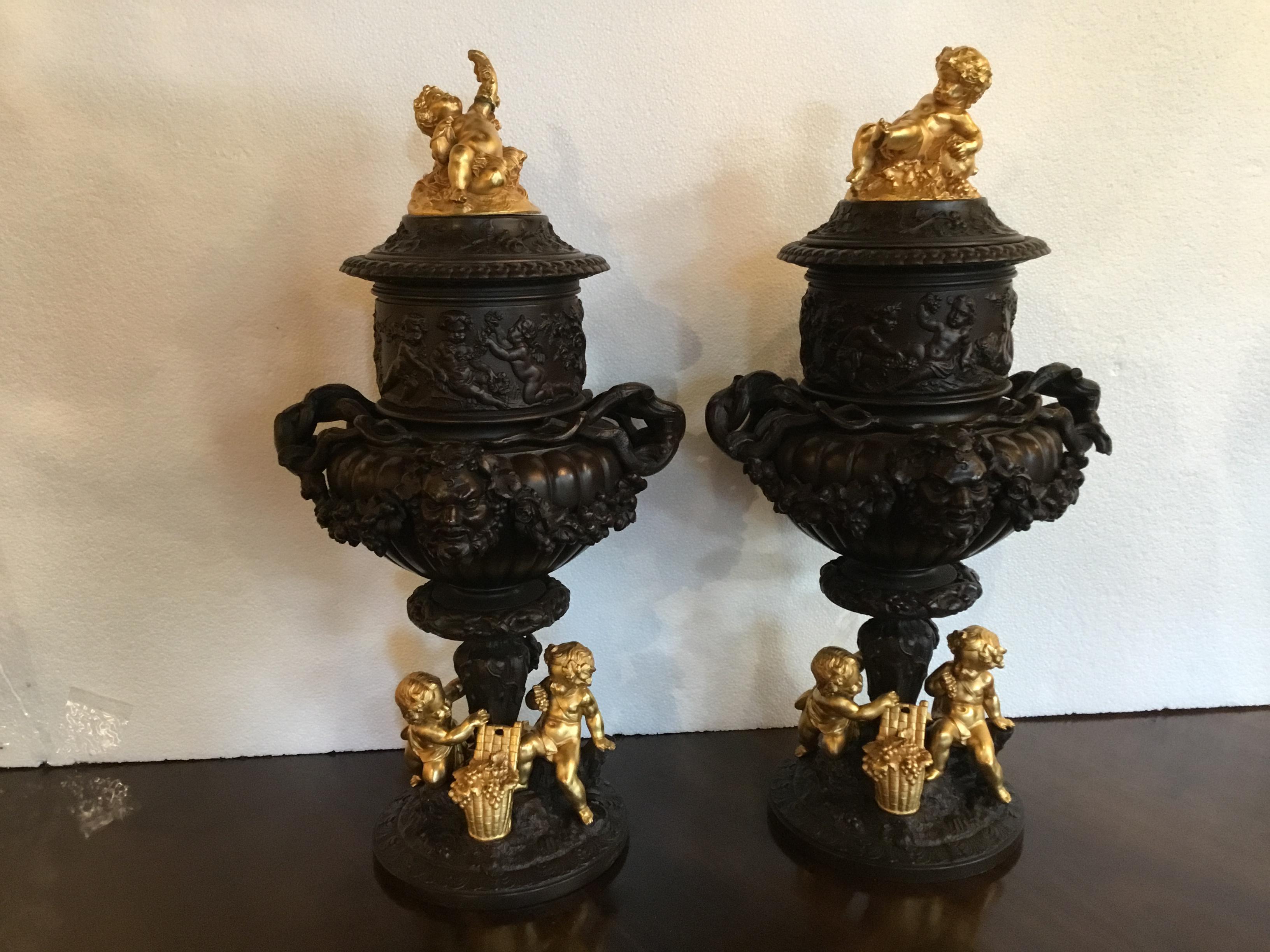 Pair of Dark Patinated Bronze Urns with Gilt Bronze Putti Caps, Baccanal Mask 1