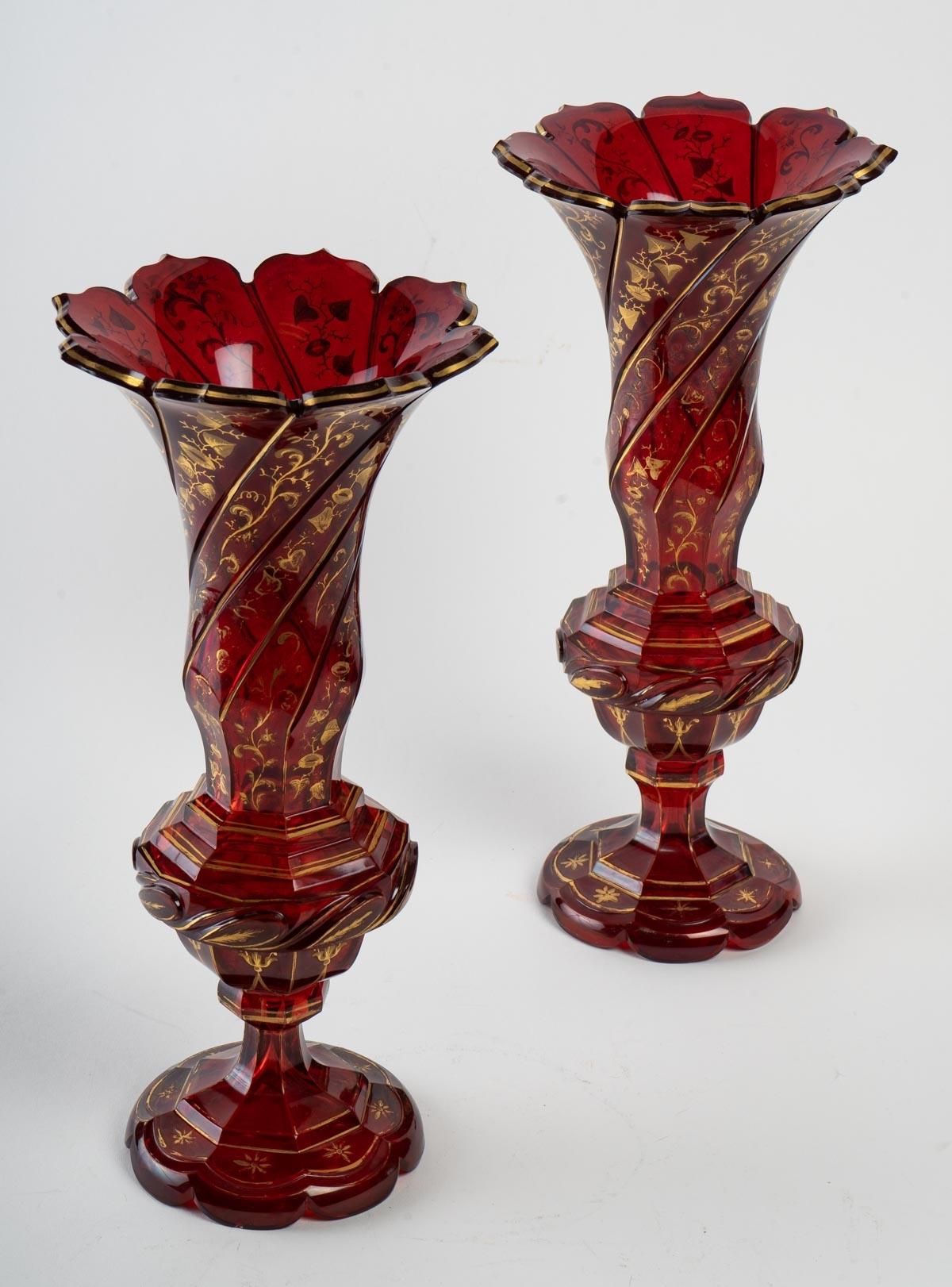Pair of dark red Bohemian crystal vases with a gold tree leaf decoration.
Measures: H 34cm, D 16cm.