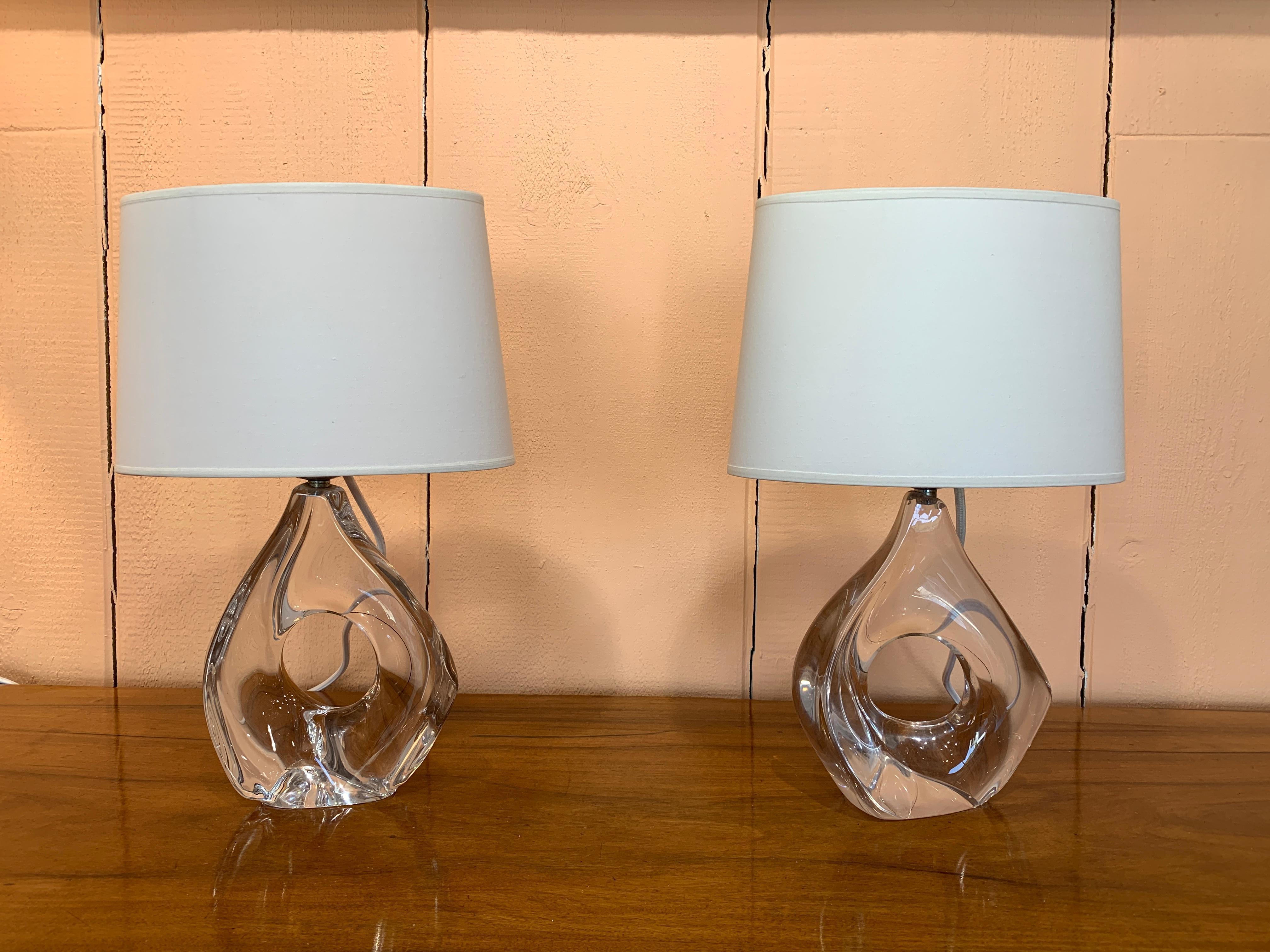 Pair of translucent crystal luminaires and cotton shade, signed Daum on the base. France, c. 1950. 
Shades and lampshades
Electrification system have been changed. In perfect working condition.