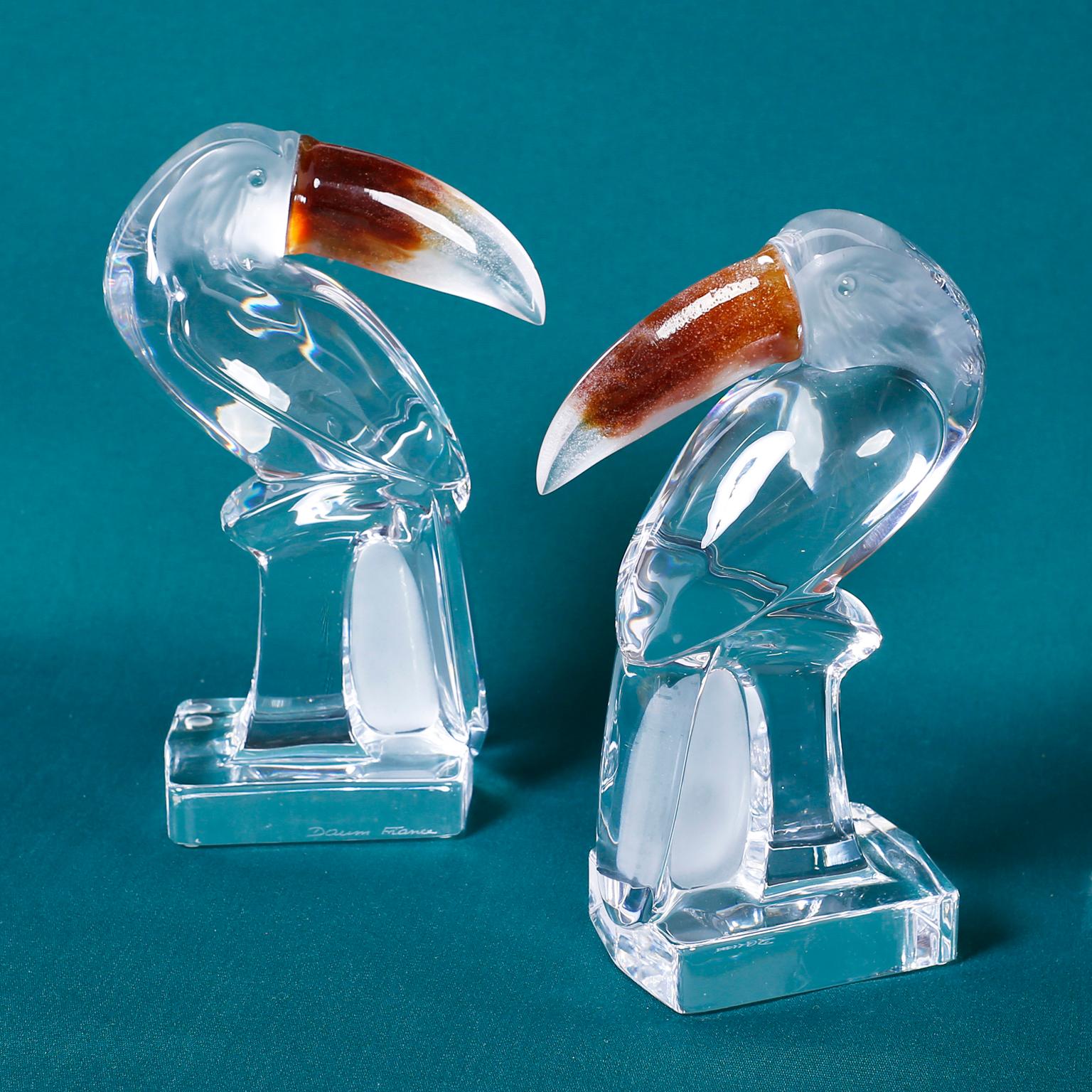 Pair of midcentury stylized glass toucans with frosted faces and amber infused beaks. Signed Daum France on the bases.