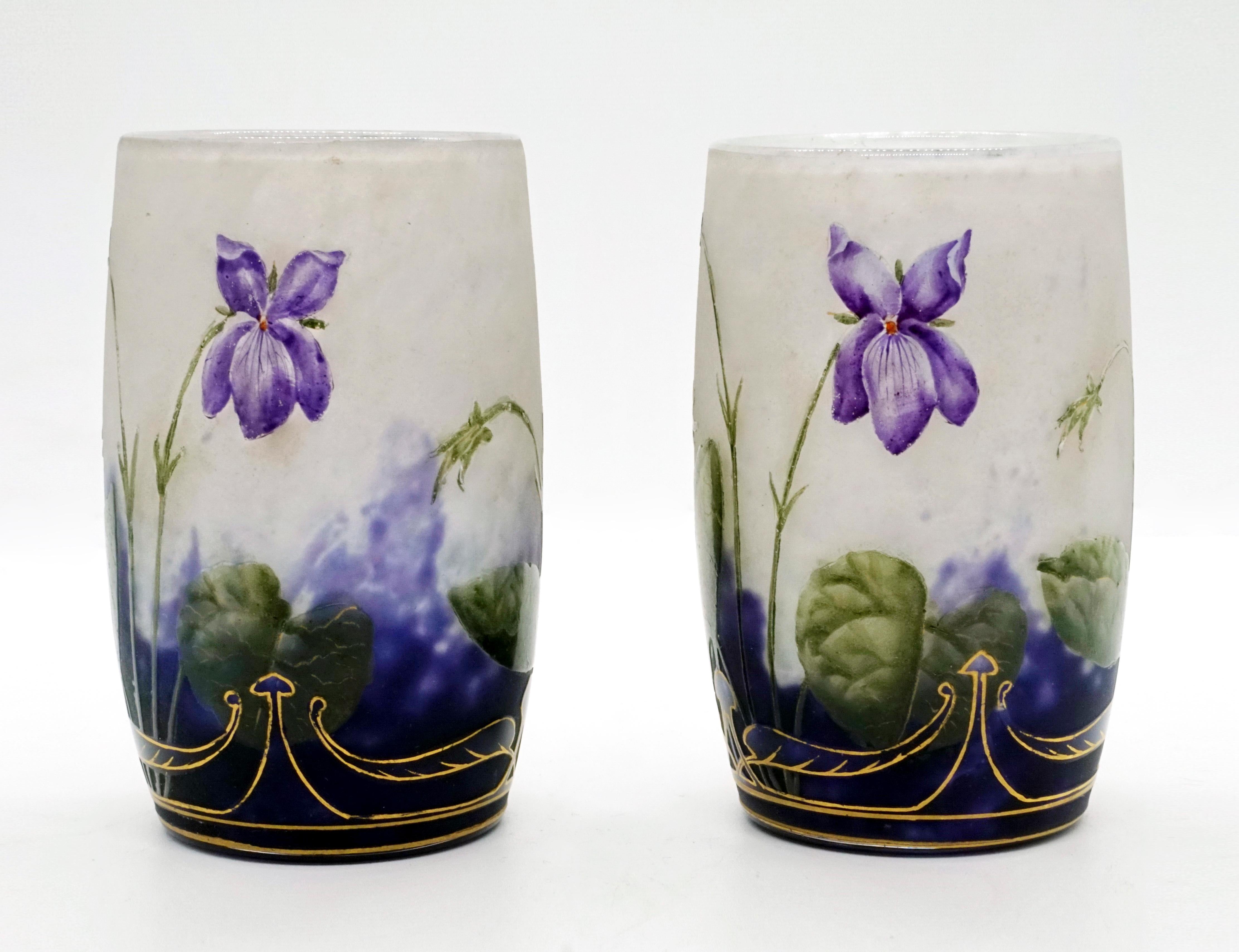 Pair of cylindrical vases, colorless glass with flaky white, in the stand area with violet powder fusions, satined surface with etched and painted in colored enamel violet decoration with gold heightening and gold decoration, gold-painted signature