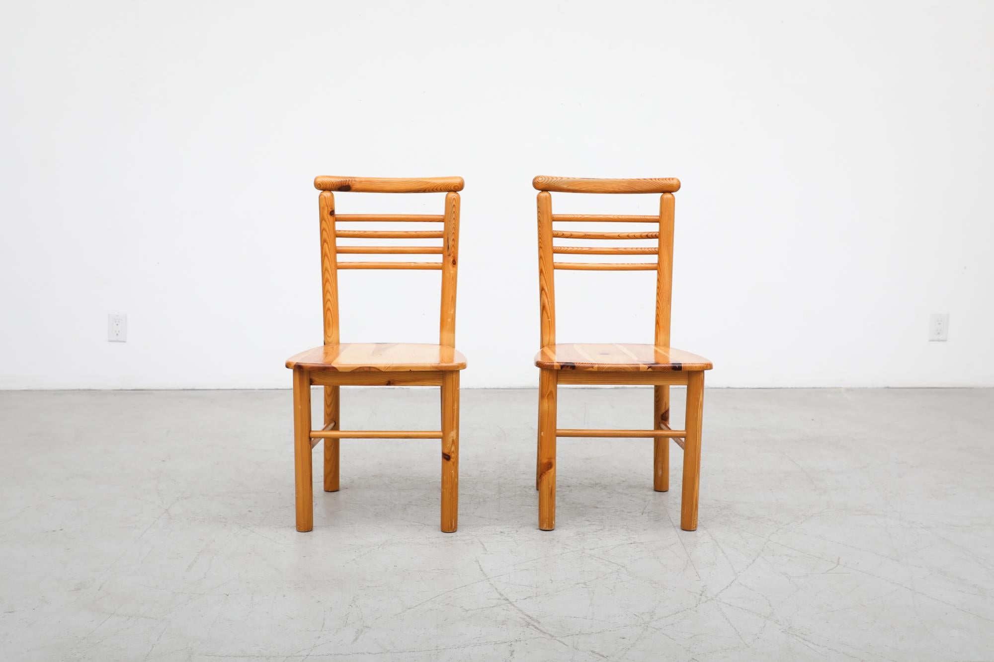 Beautiful pair of Mid-Century solid pine ladder back side chairs with rounded frame. In original condition with with visible wear including some scratching. Wear is consistent with their age and use. Set price.
