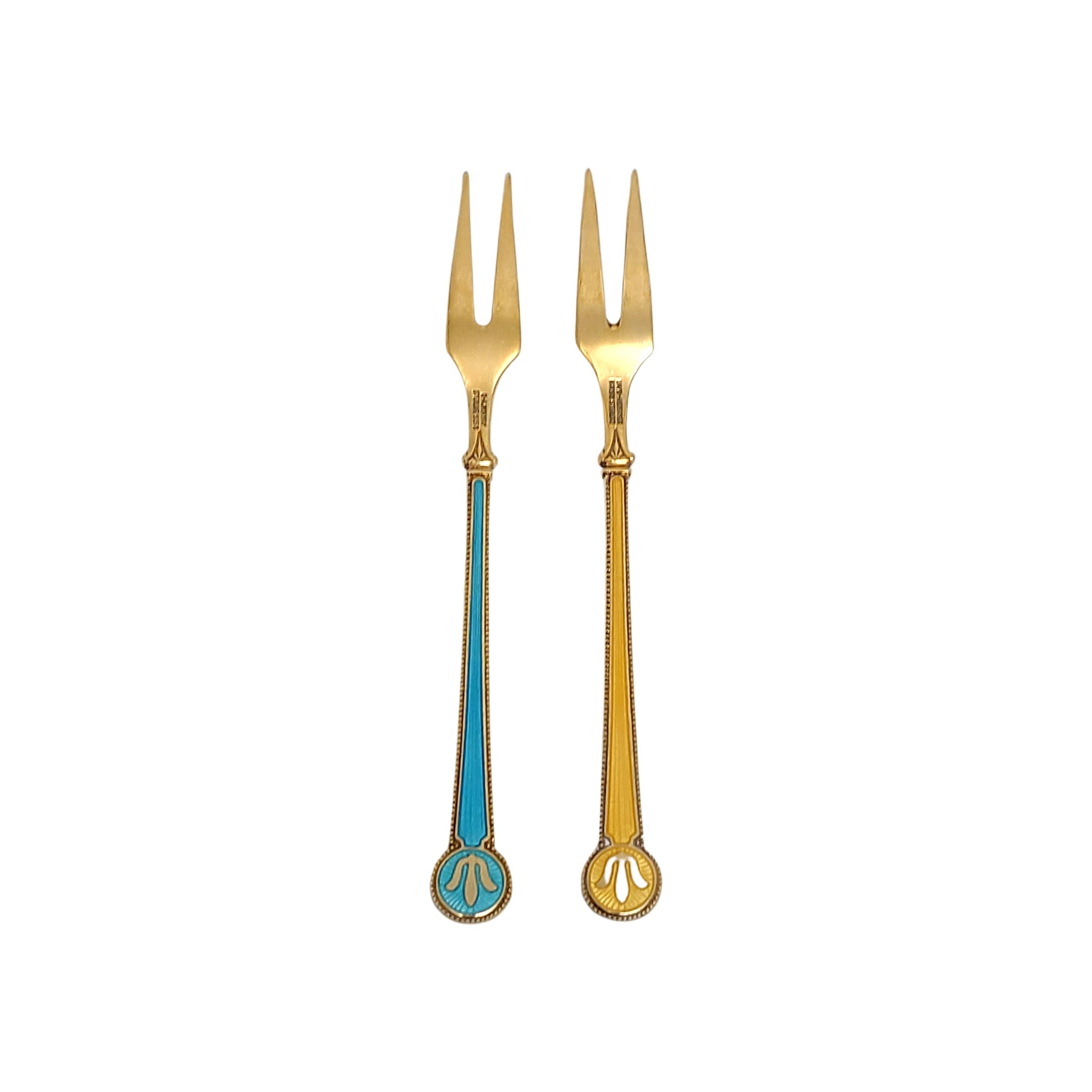 Pair of vintage gold plate over sterling silver and enamel demitasse cocktail forks, by David Andersen Denmark.

Beautifully enameled forks in yellow and light blue. Both sides of the handles are enameled, featuring a gold plate beaded edge and a