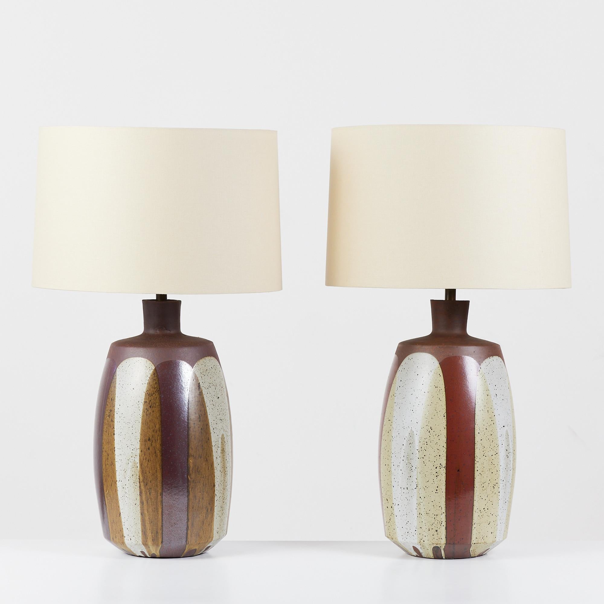 Pair of David Cressey flame glaze lamps, c.1960's, USA. The wheel thrown stoneware lamps feature a speckled flame glaze detail. The glaze pattern drip lines terminate near the base of the lamp, mimicking the pattern of flames. The newly rewired