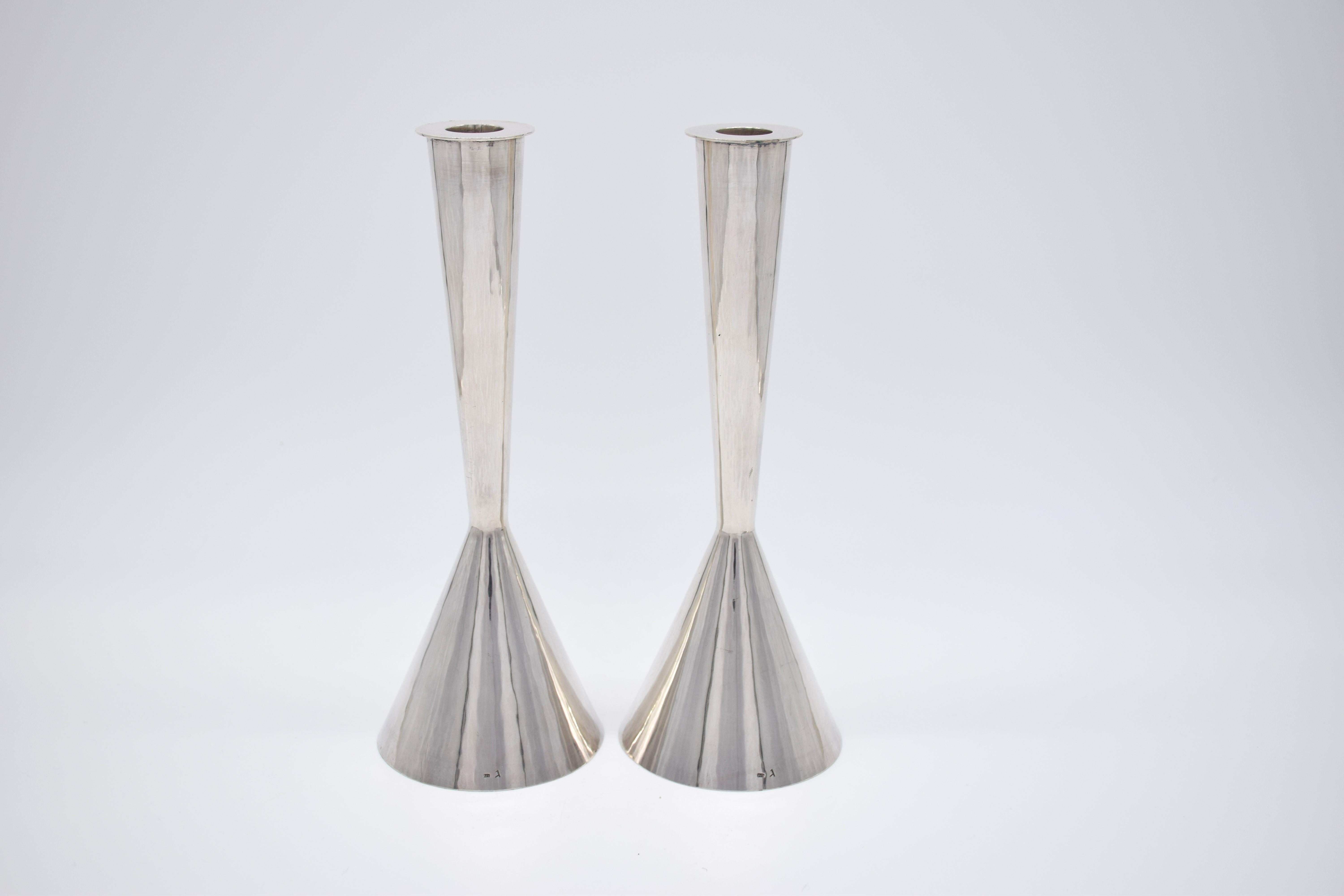We are offering here this perfectly designed pair of sterling silver candlesticks, all hand Hammered in a fine and sleek Bauhaus design, the candlesticks were made after Gumbel Left his work in the bezalel school of arts in Jerusalem, they date from