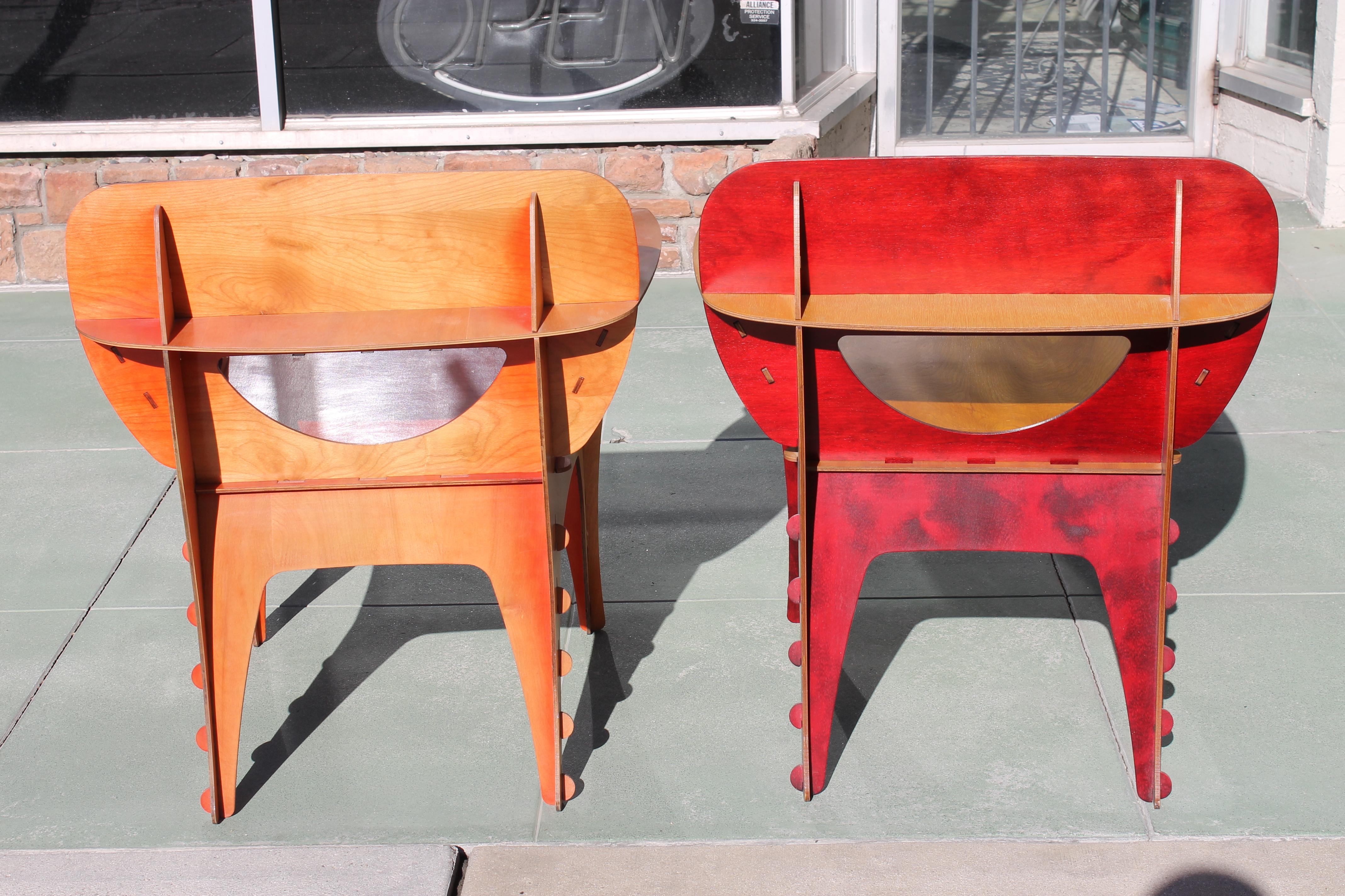 Two chairs by David Kawecki, San Francisco. Original birch plywood design stained reds. Chairs measure 29.5” wide, 25” deep, 33” high. Seat height is 18