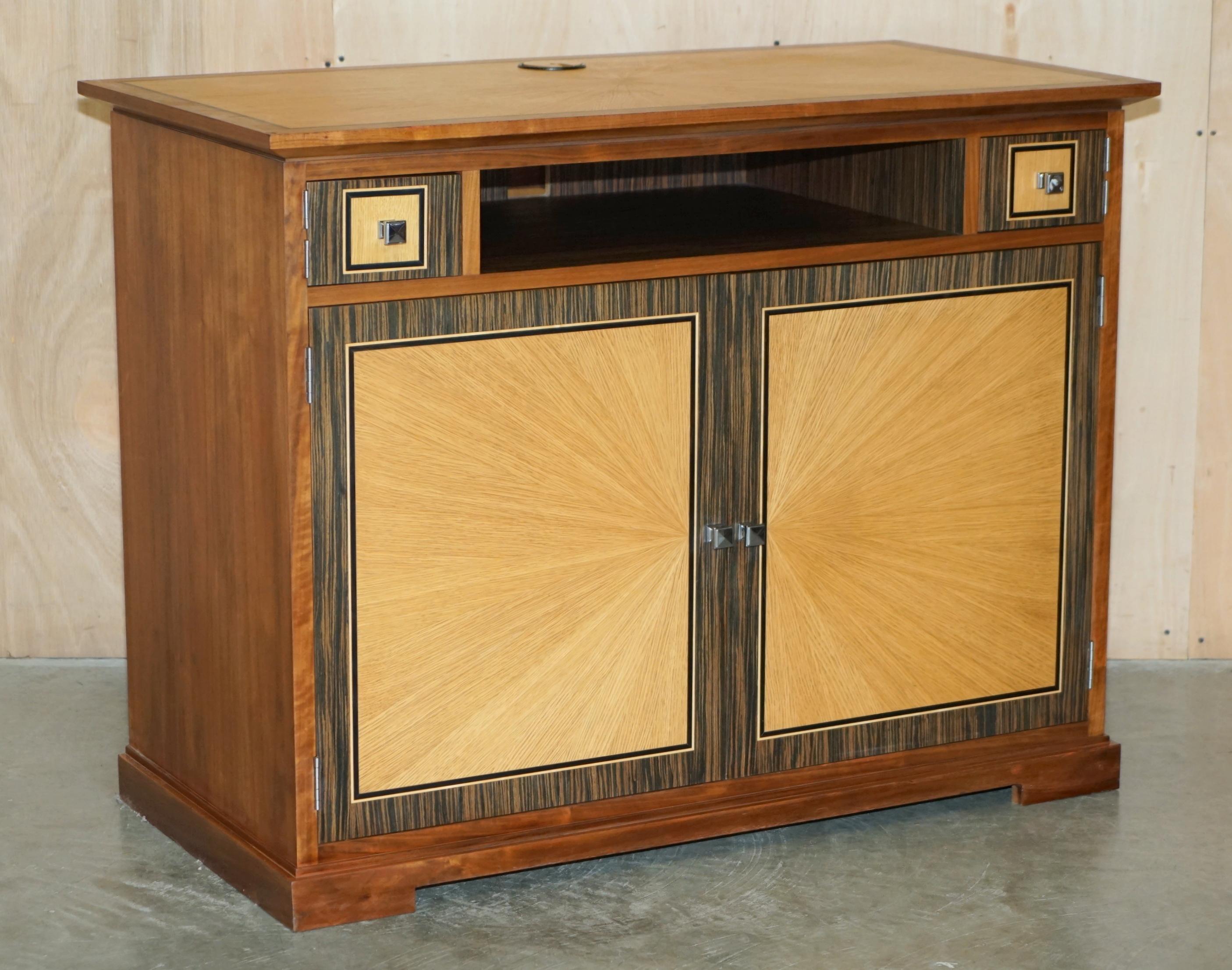 Royal House Antiques

Royal House Antiques is delighted to offer for sale this absolutely exquisite pair of Viscount David Linley Satinwood & Macassar Ebony sideboards designed to seat a television and house media boxes

Please note the delivery fee