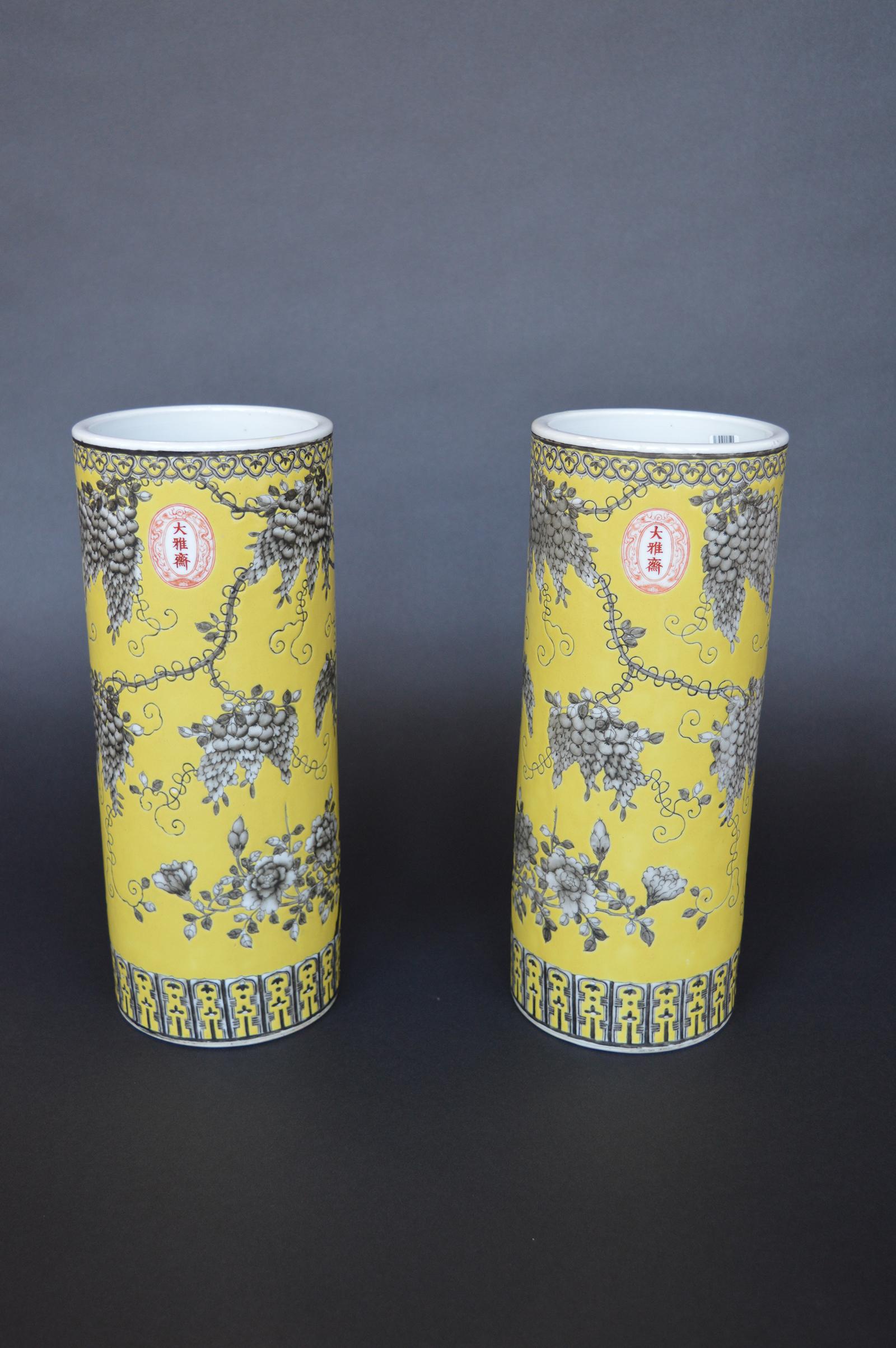 A pair of Dayazhai yellow-ground grisaille-decorated cylindrical vases.
Guangxu, Dayazhai three-character marks and Yong qing chang chun four-character marks
Each vase delicately enamelled in mirror image with a red-tongued bird perched on a