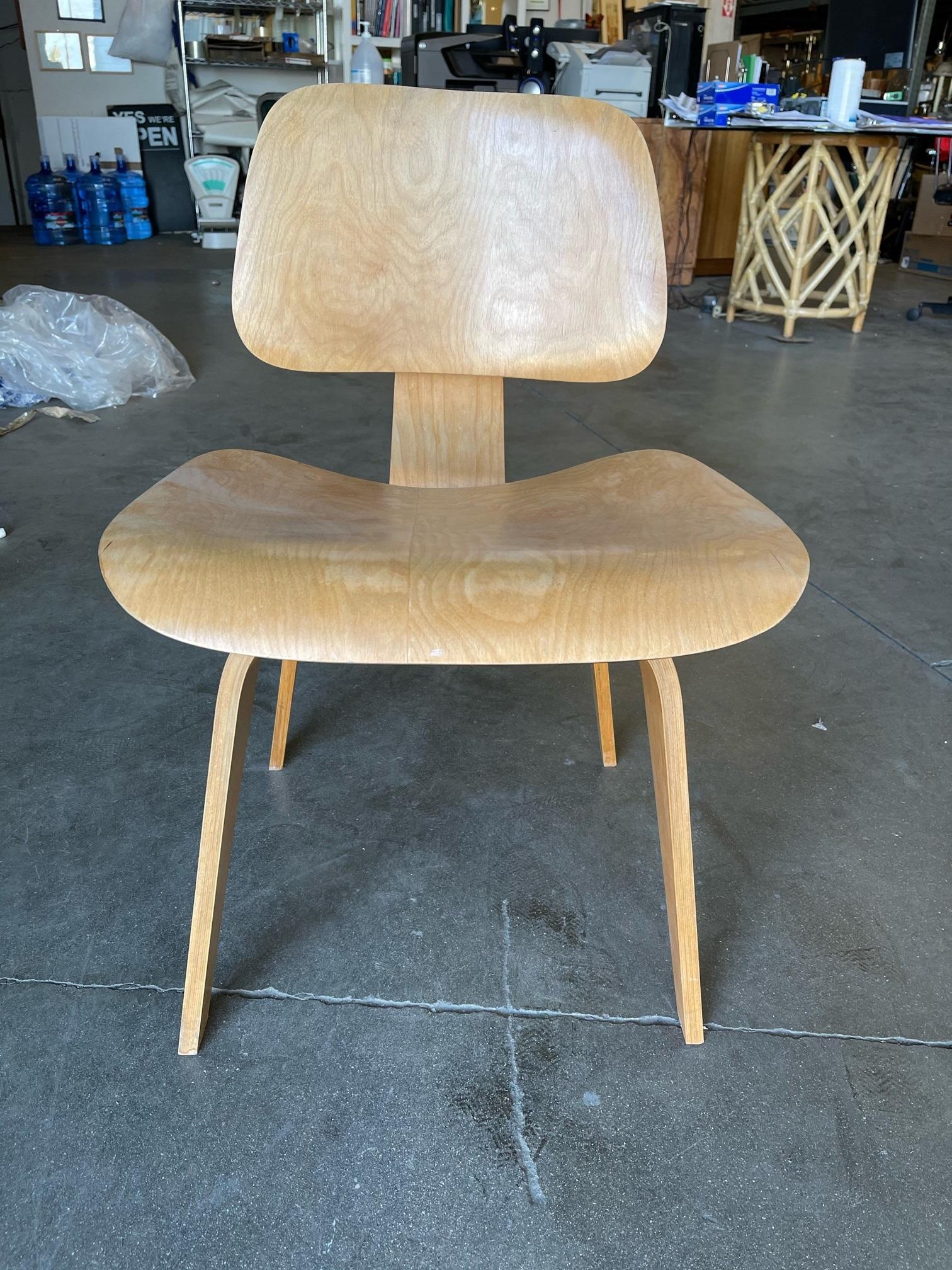 This pair of early 1948 DCW chairs designed by Charles and Ray Eames for Herman Miller. Both pieces have their original Evans Foil Labels used by Herman Miller from 1947-1950. Both chairs have early single rubber shock mounts with the 5-2-5 mounting