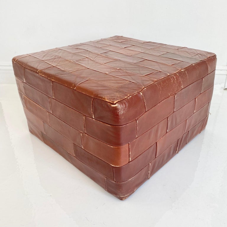 Gorgeous brown leather ottomans by De Sede. Leather rectangular patchwork. Perfect accent piece. Good coloring and patina. Good vintage condition. Wear to leather as shown in photos. Matching set. Priced as a pair.

 